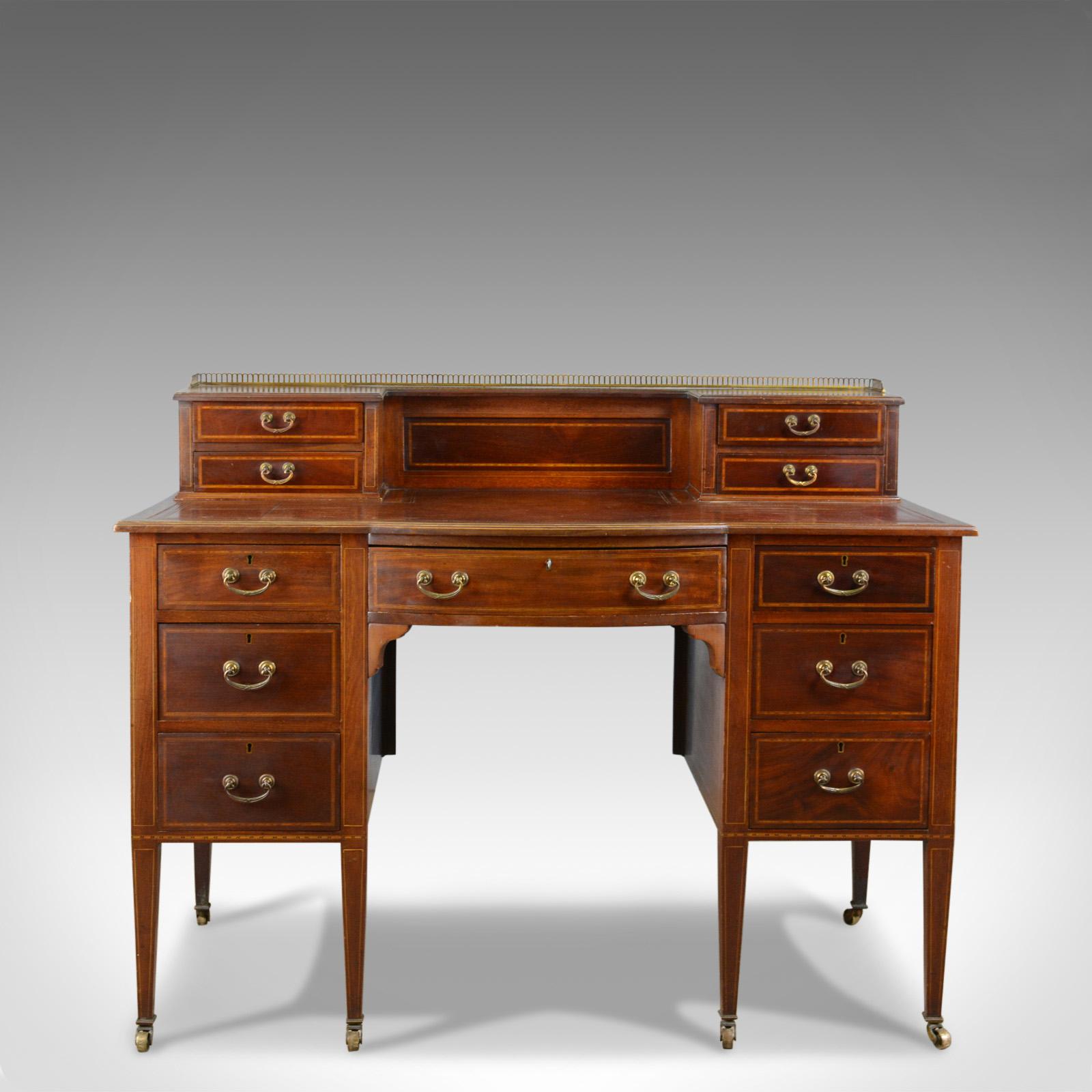 This is an antique writing desk, an English, Edwardian, mahogany knee-hole desk dating to the early 20th century, circa 1910.

An attractive writing desk of good proportion
Select mahogany displaying rich tones of russet hues
Grain interest