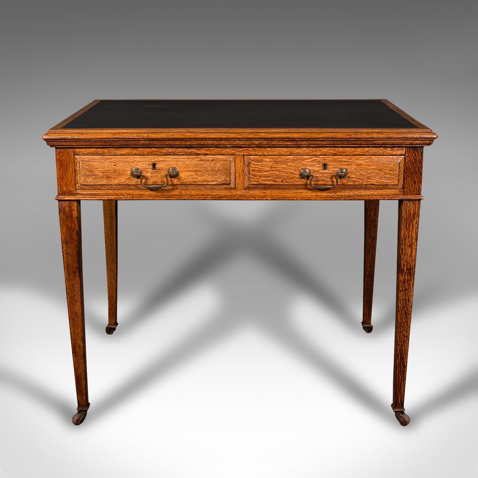 This is an antique writing desk. An English, oak and leather correspondence table, dating to the Edwardian period, circa 1910.

Of useful proportion and beautifully figured
Displays a desirable aged patina and in good order
Striking quarter sawn oak