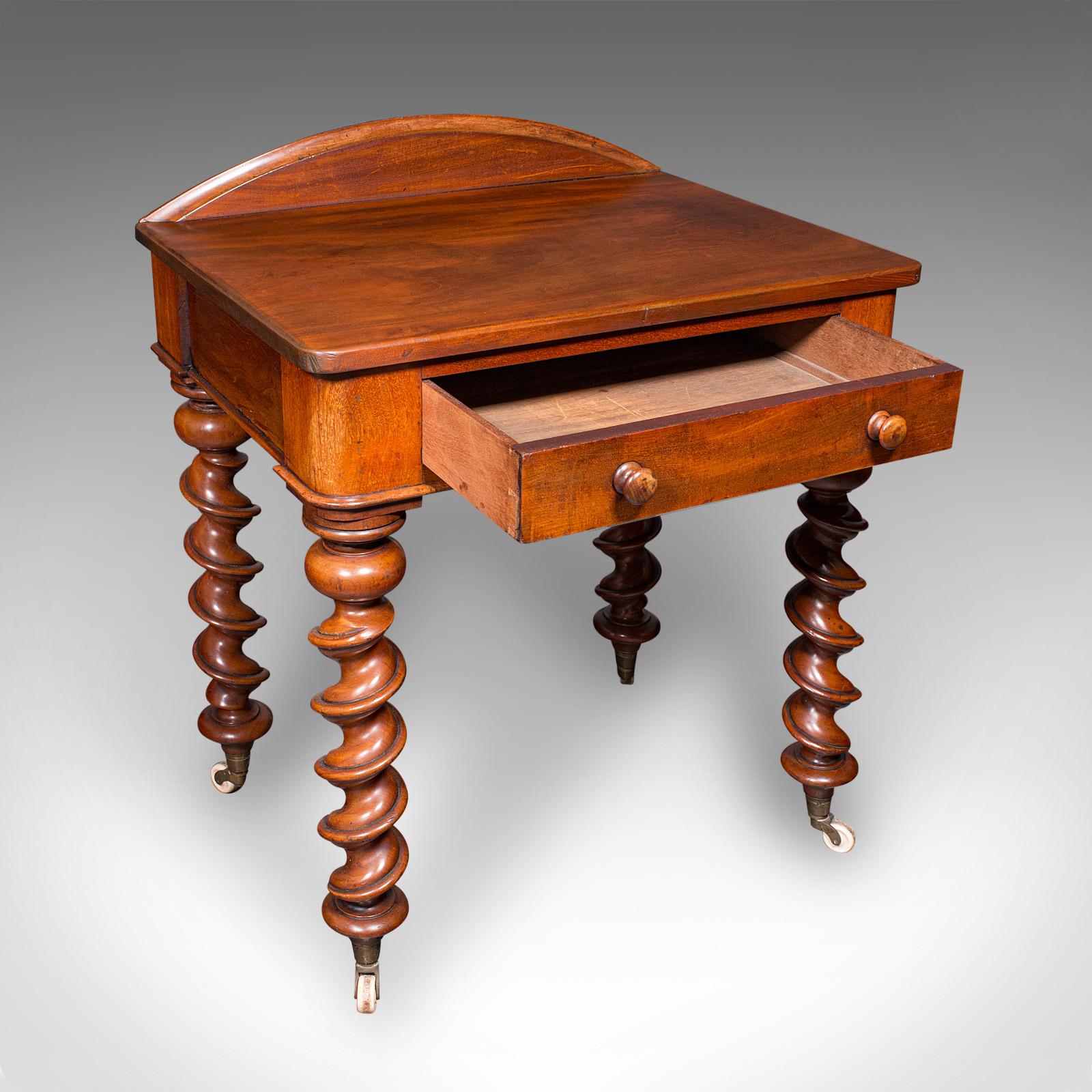 This is an antique writing desk. An English, mahogany side table, dating to the late Victorian period, circa 1890. A delightful example, presenting fine English craftsmanship and enduring charm. This elegant piece exudes the refinement of the late