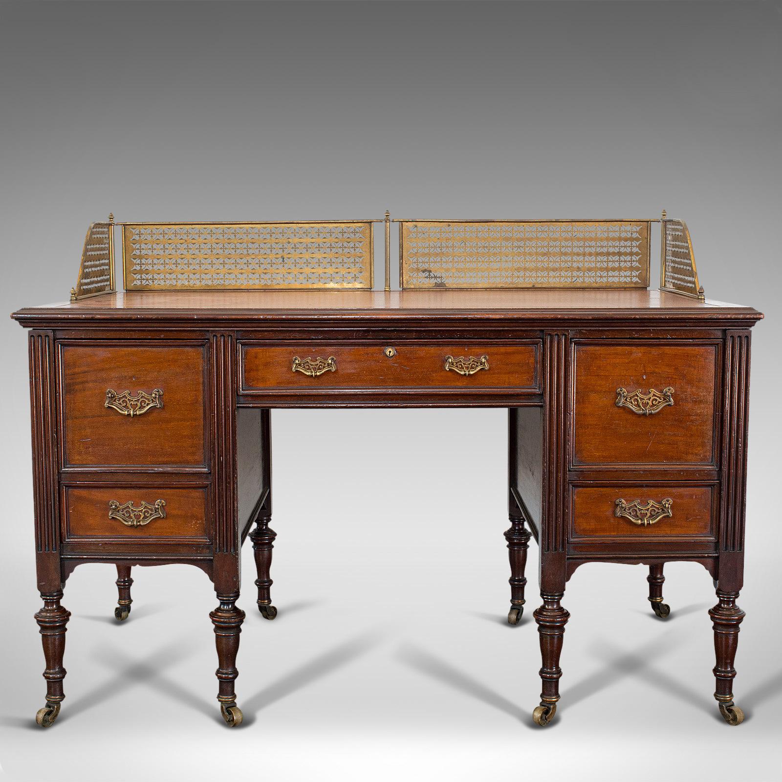 This is an antique writing desk. An English, walnut office desk by the renowned Maple & Co of London, dating to the late 19th century, circa 1900.

Elegant writer's desk from the coveted Maple & Co
Displays a desirable aged patina
Select walnut