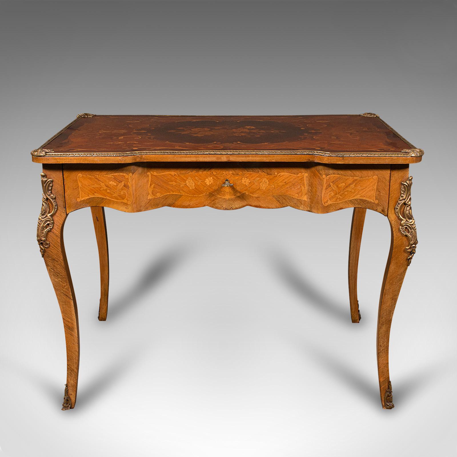 This is an antique writing desk. A French, kingwood reverse breakfront decorative centre table in Louis XV revival taste with marquetry top, dating to the late Victorian period, circa 1900.

Graced with exquisite marquetry and craftsmanship - a