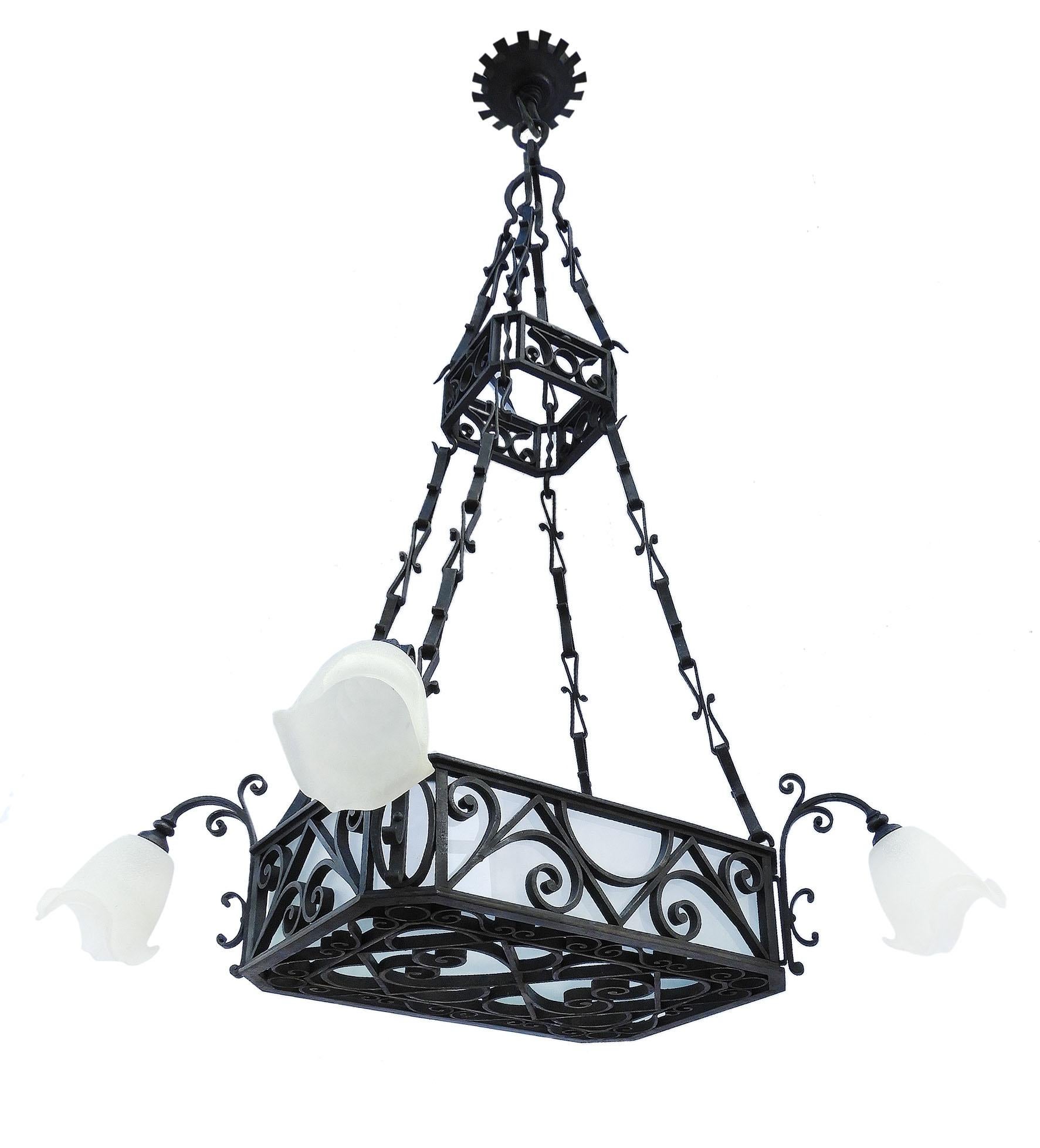 Large French wrought iron and frosted glass chandelier, circa 1900. A stunning and rare find from a restaurant in Biarritz, France, popular during the Belle Époque era. Heavy Artisan made chandelier with a central basket lined with frosted glass and
