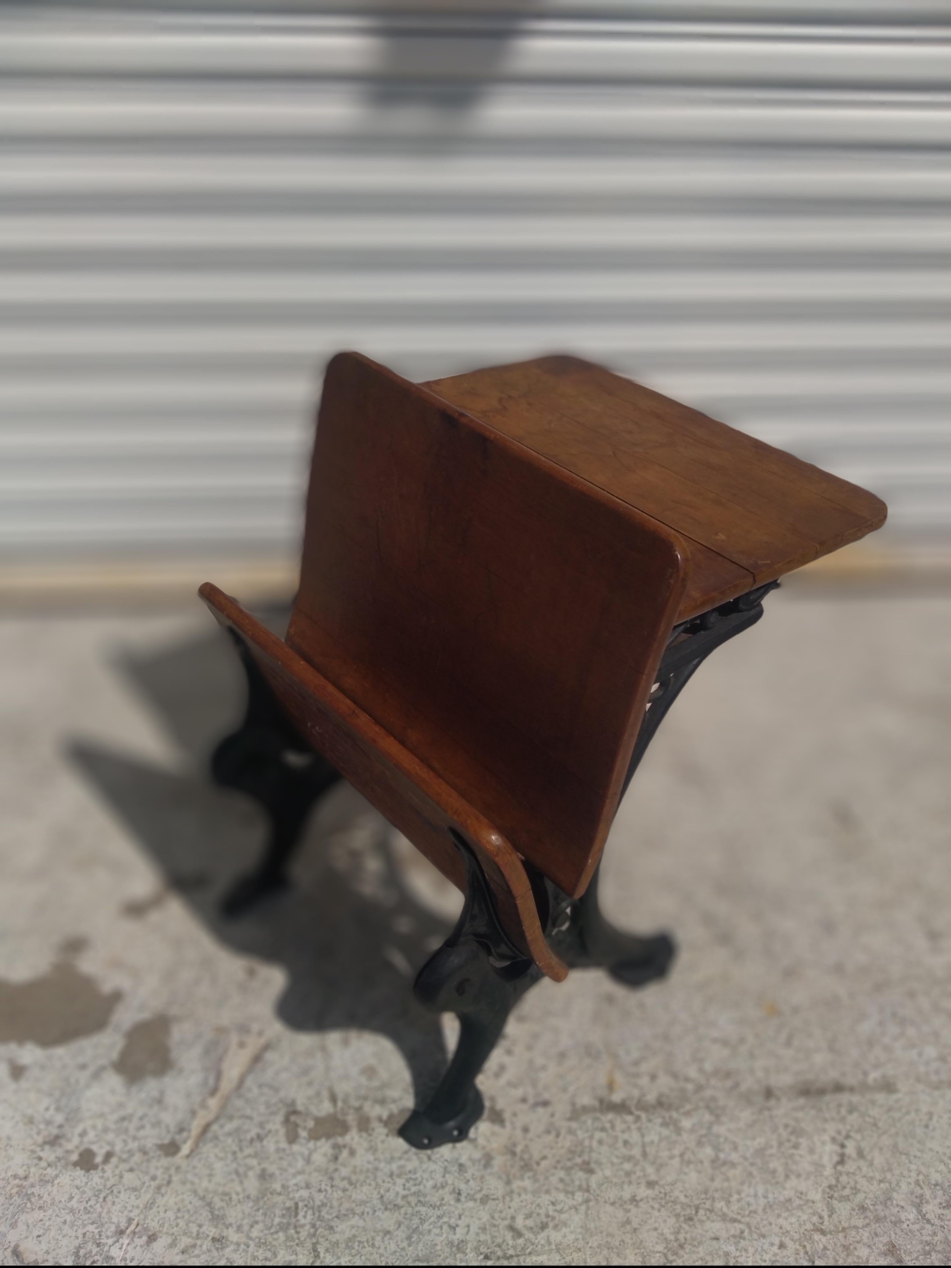 This is an old antique students desk. The base is composed of wrought iron construction. The seat folds up and the back has a place for storage. The wood has a beautiful time weathered patina. 

There are multiple desk available.