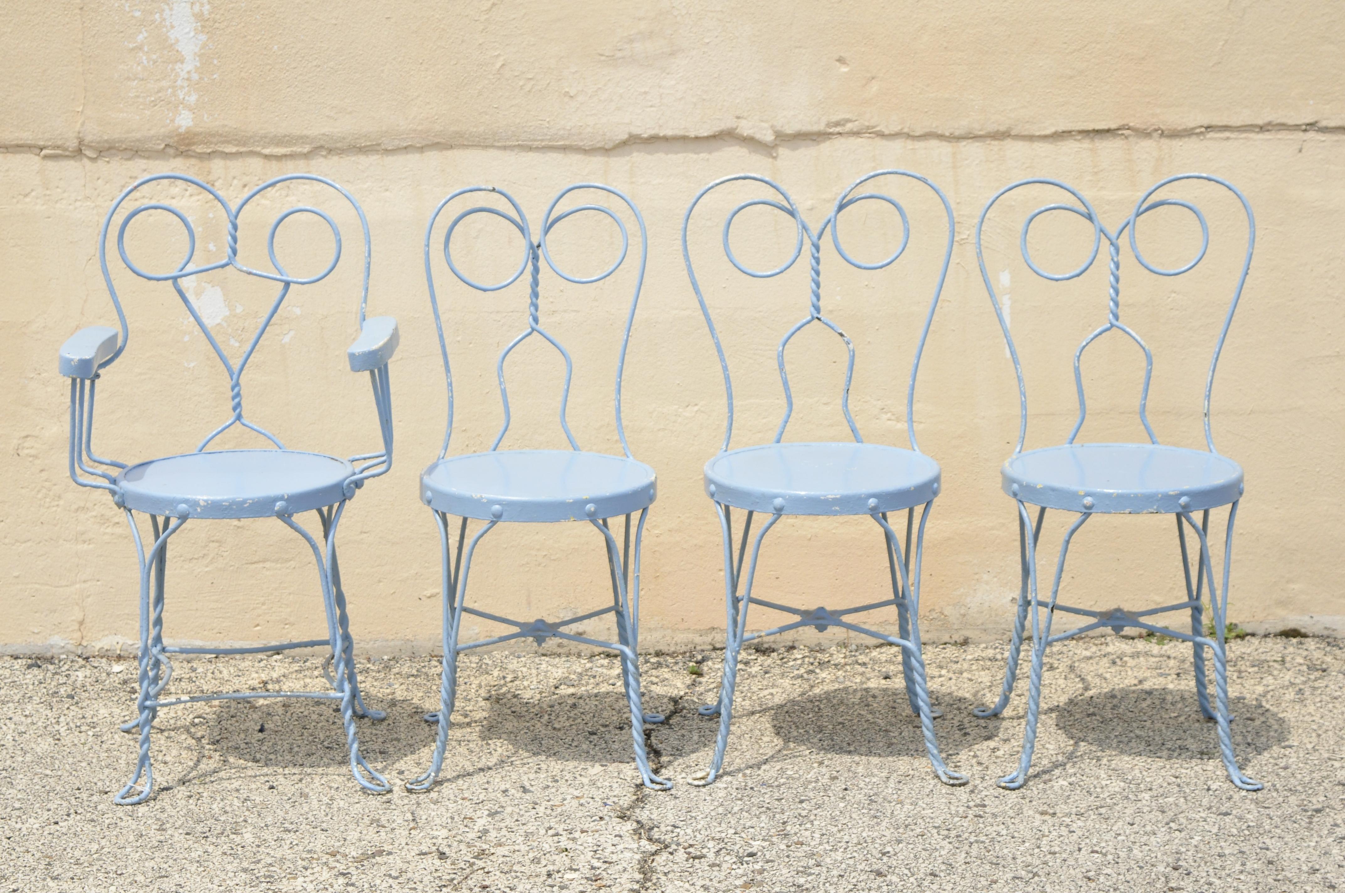 Antique wrought iron blue heart back ice cream parlor bistro dining set 4 chairs round table - 5pc set. Set includes (1) armchair, (3) side chairs, twisted wrought iron bases, round wooden table top, blue painted finish, very nice antique set, great
