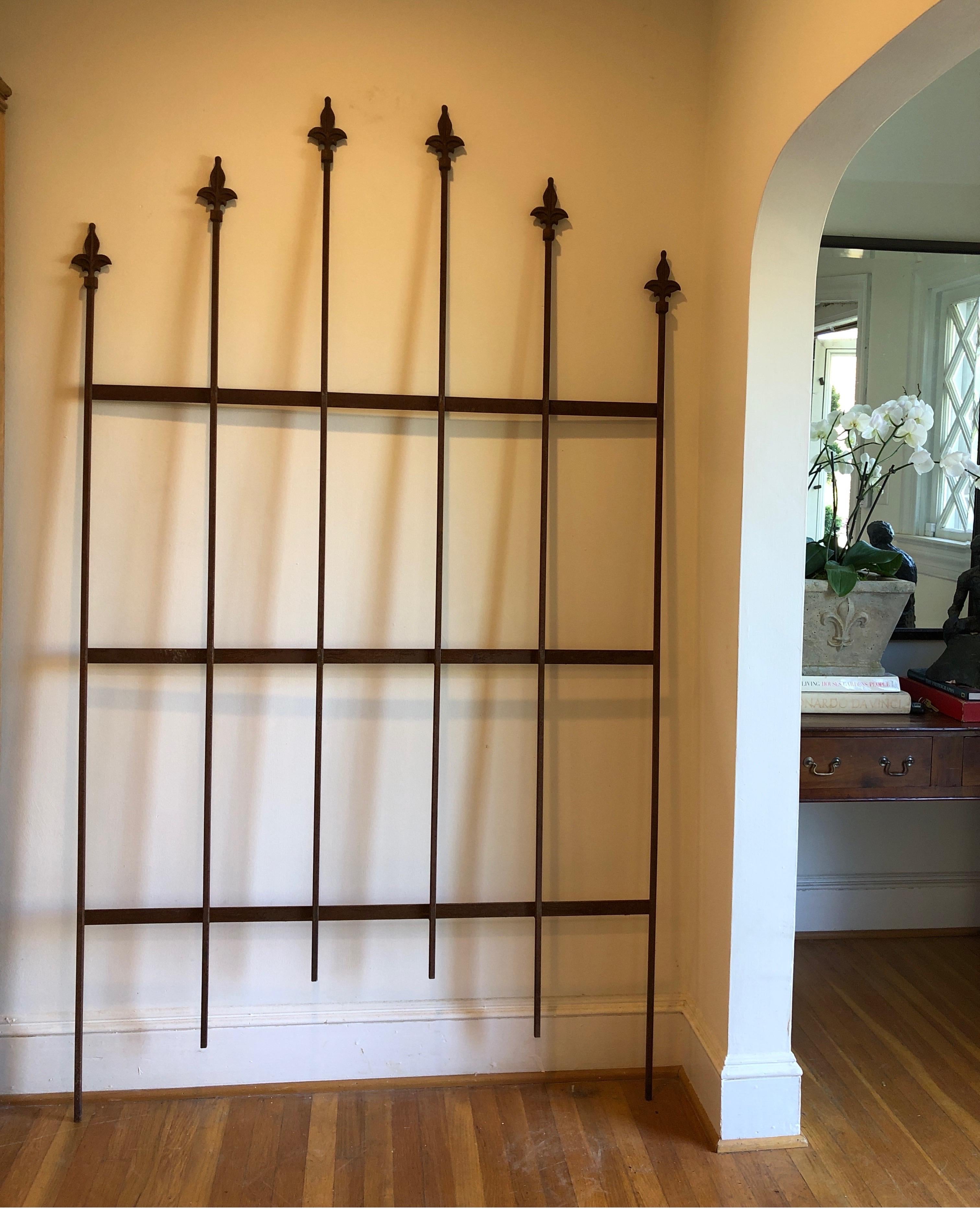 Rare set of 35 matching panels of antique wrought iron fencing with arched fleur di lys (Fleur-di-lis) Finials atop each rail. Very simplistic yet regal Victorian-era ornamental ironwork. All Hand Forged panels and truly hard to find in such a large