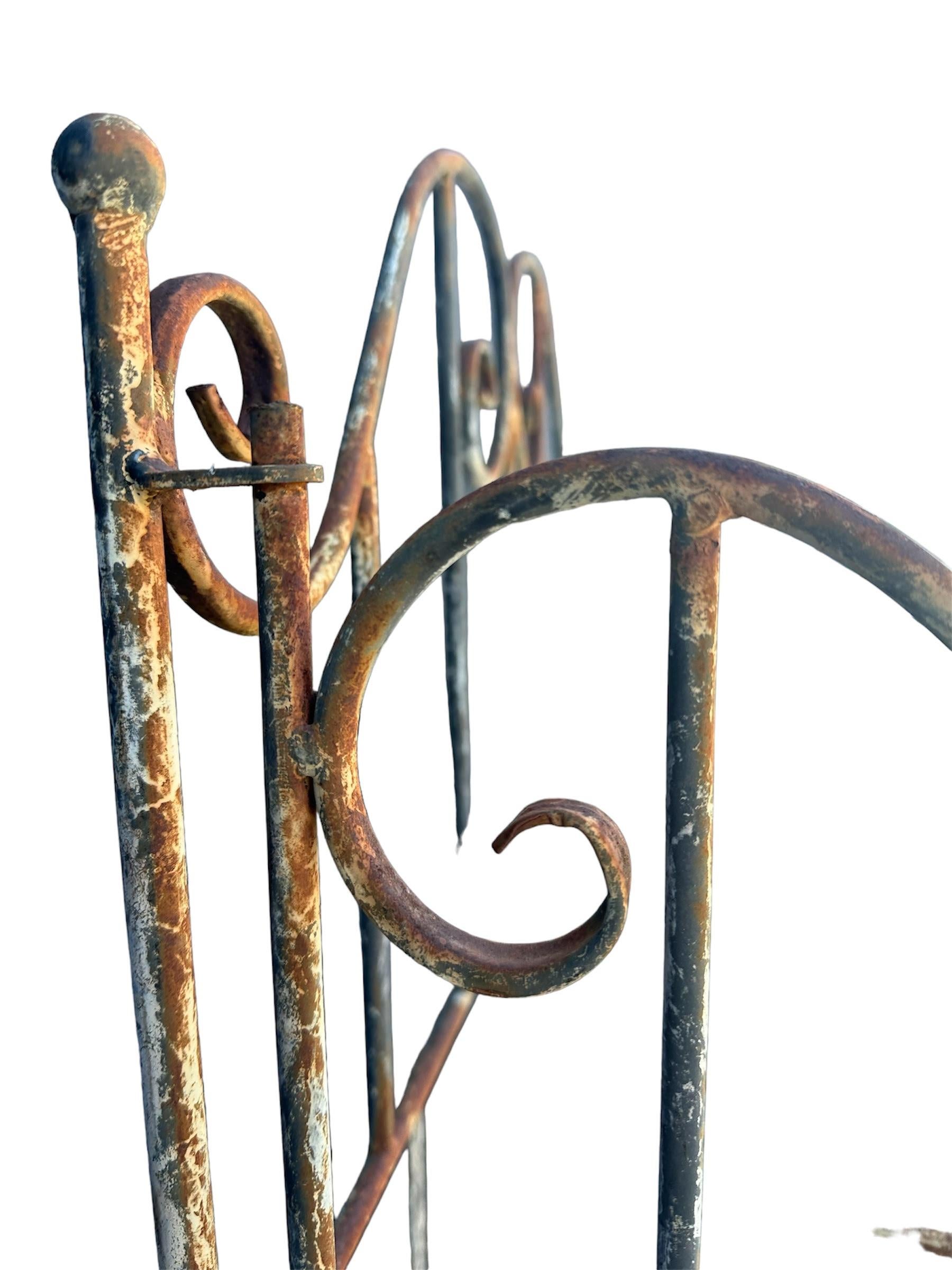 Hand-crafted in France during the 20th century, this unique display cabinet showcases elegant metalwork accentuated by the flowing outlines of wrought iron. Featuring five retractable shelves, creating space for larger items... Perfect for in or