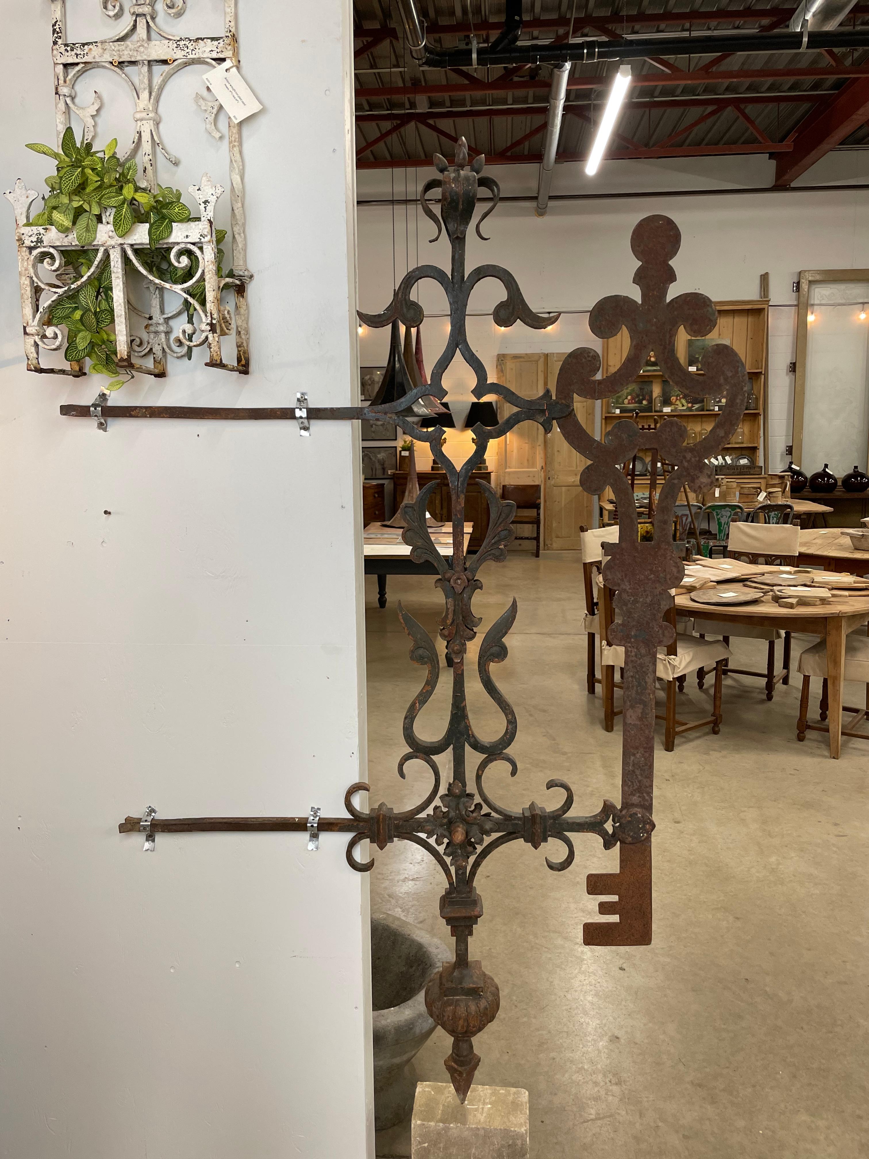 Rare antique wrought iron trade sign, in the form of a very decorative key, that once hung outside a French locksmith and key maker’s shop.

It has the most beautiful patina with faint remnants of old dark green paint. The intricate wrought iron