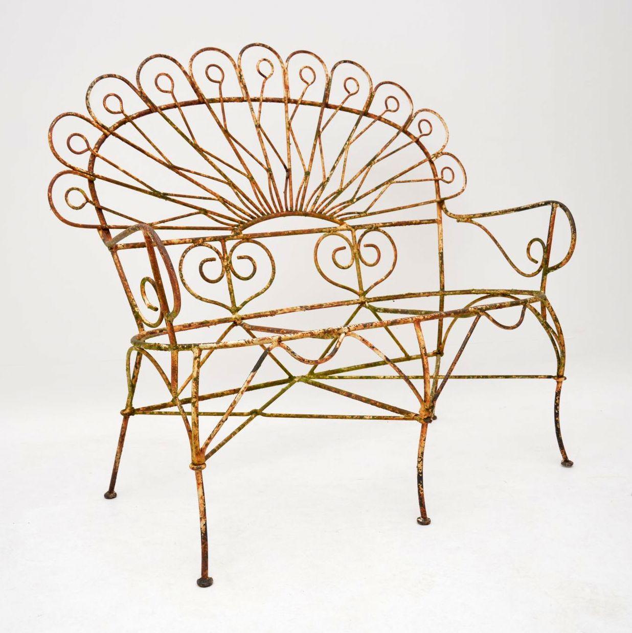 Antique distressed painted wrought iron garden seat, two matching chairs and table. The seat and chairs have quite an unusual style & I can’t quite work out the age or country of origin. We took them out of a garden from a London residence along