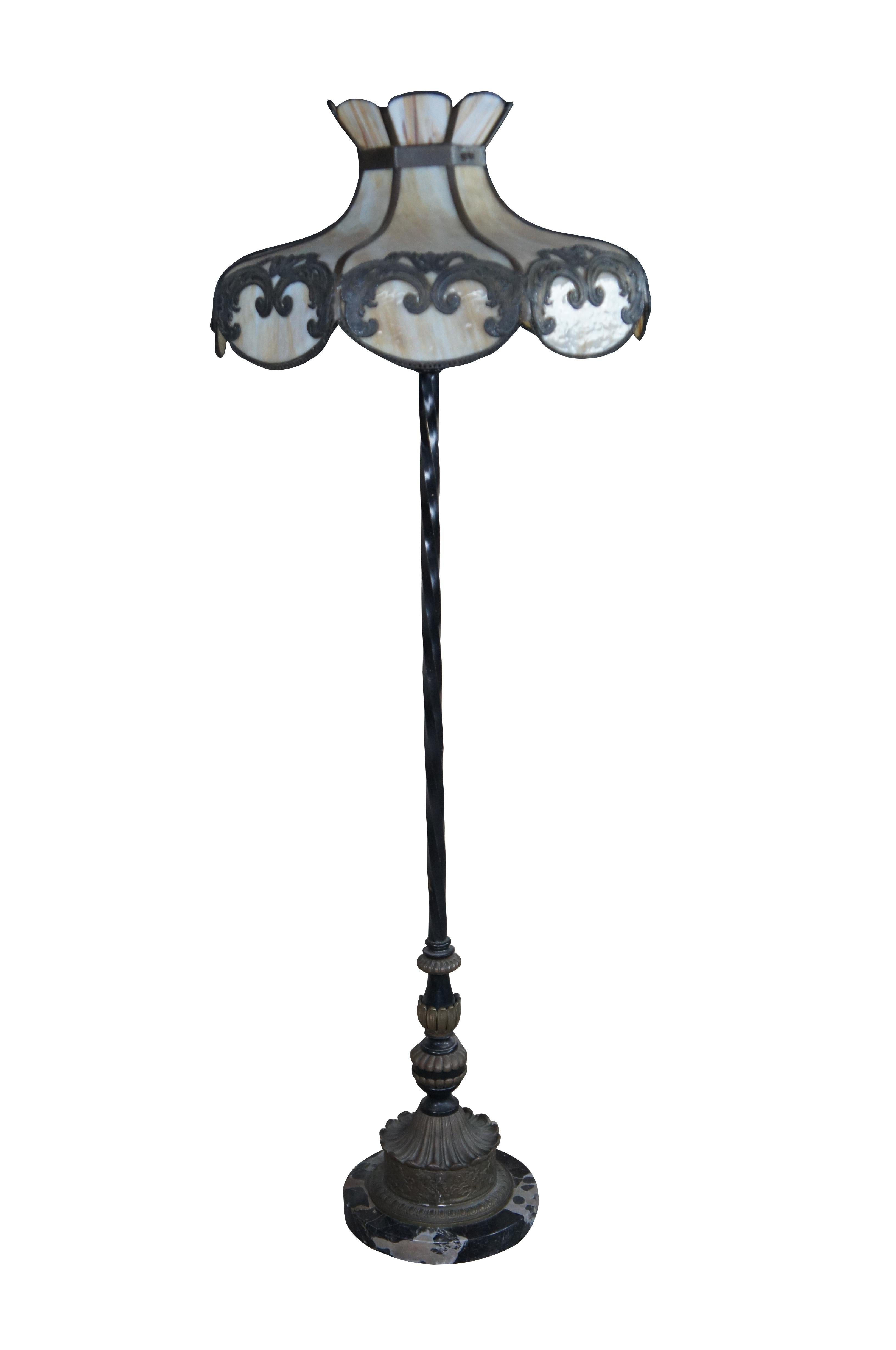 Antique wrought iron Tiffany style floor lamp featuring a stained slag glass shade with art nouveau acanthus design supported by twisted iron body with brass equestrian / horse theme accents and marble base.

Dimensions:
66