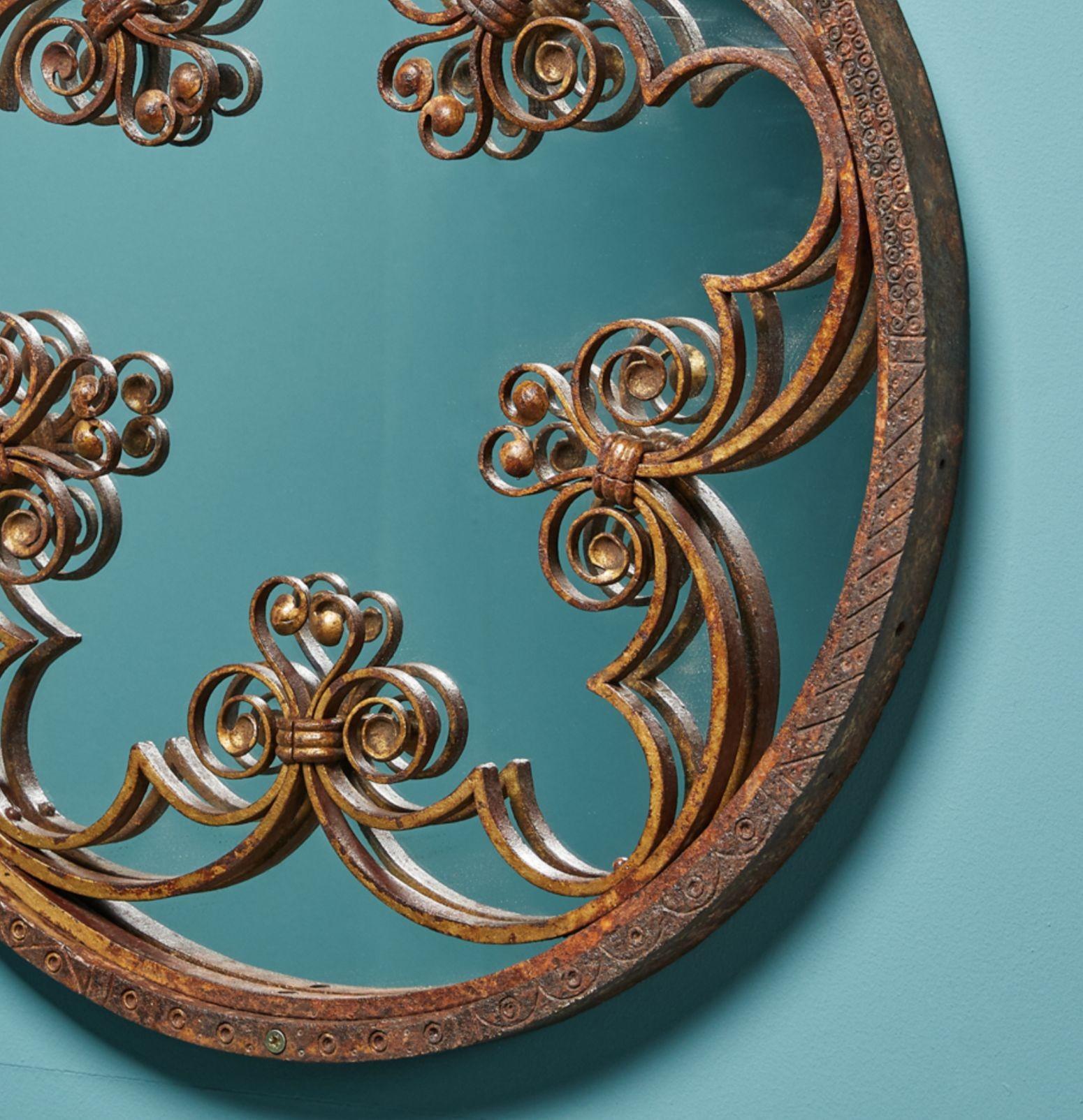 Ornately decorated with arched trefoils and twisted detailing, this antique wrought iron mirror is an elegant showpiece in any space. The ironwork is believed to have been taken from Salisbury Cathedral in the UK, known for its gothic architecture,