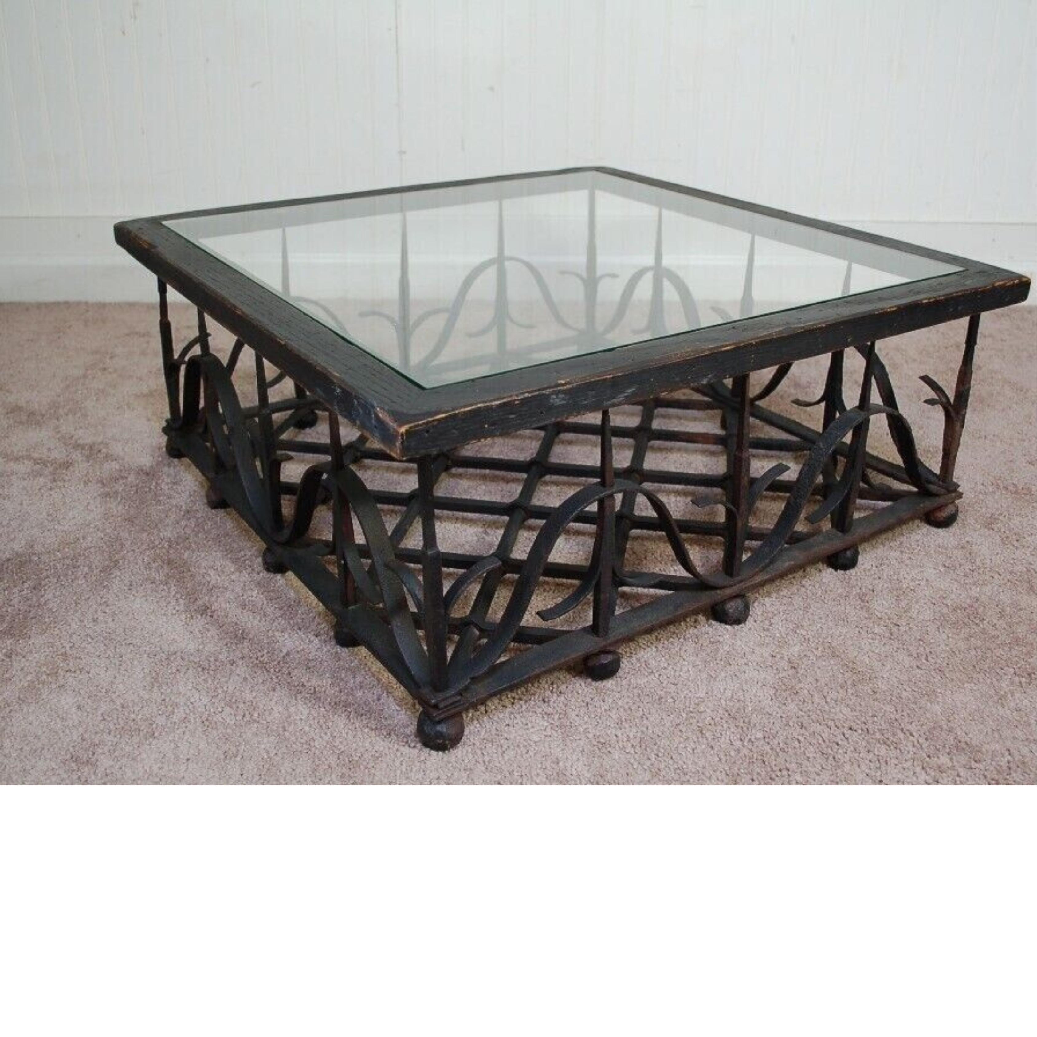 Antique Wrought Iron Mission Arts & Crafts Coffee Table in the style of Samuel Yellin. Item base features an intricate woven wrought iron pattern raised on ball form feet top with a wooden frame and inset glass. Circa 1900s. Measurements: 10.5