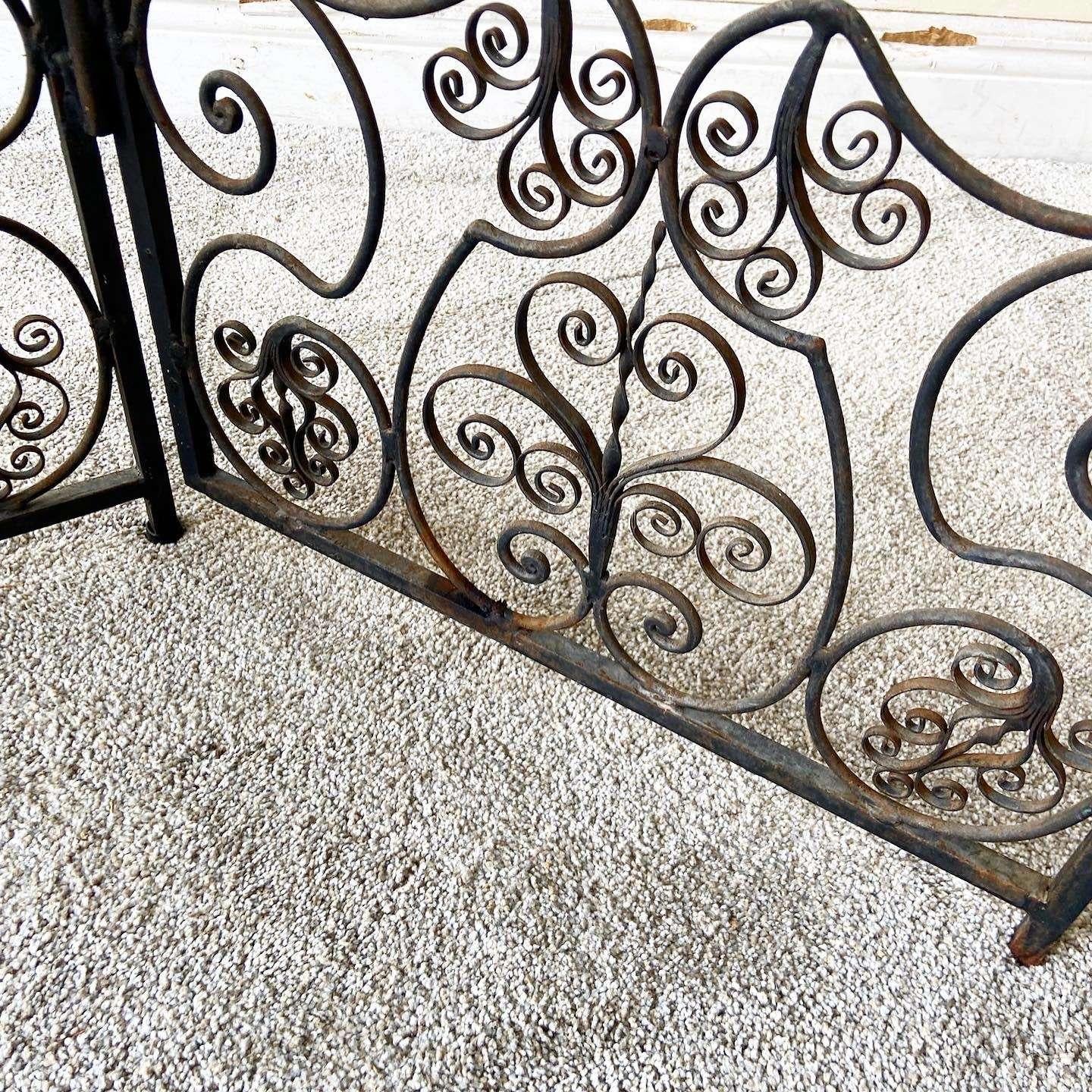 Amazing 4 panel wrought iron room divider/screen. Features and ornate sculpted design with a black finish.
