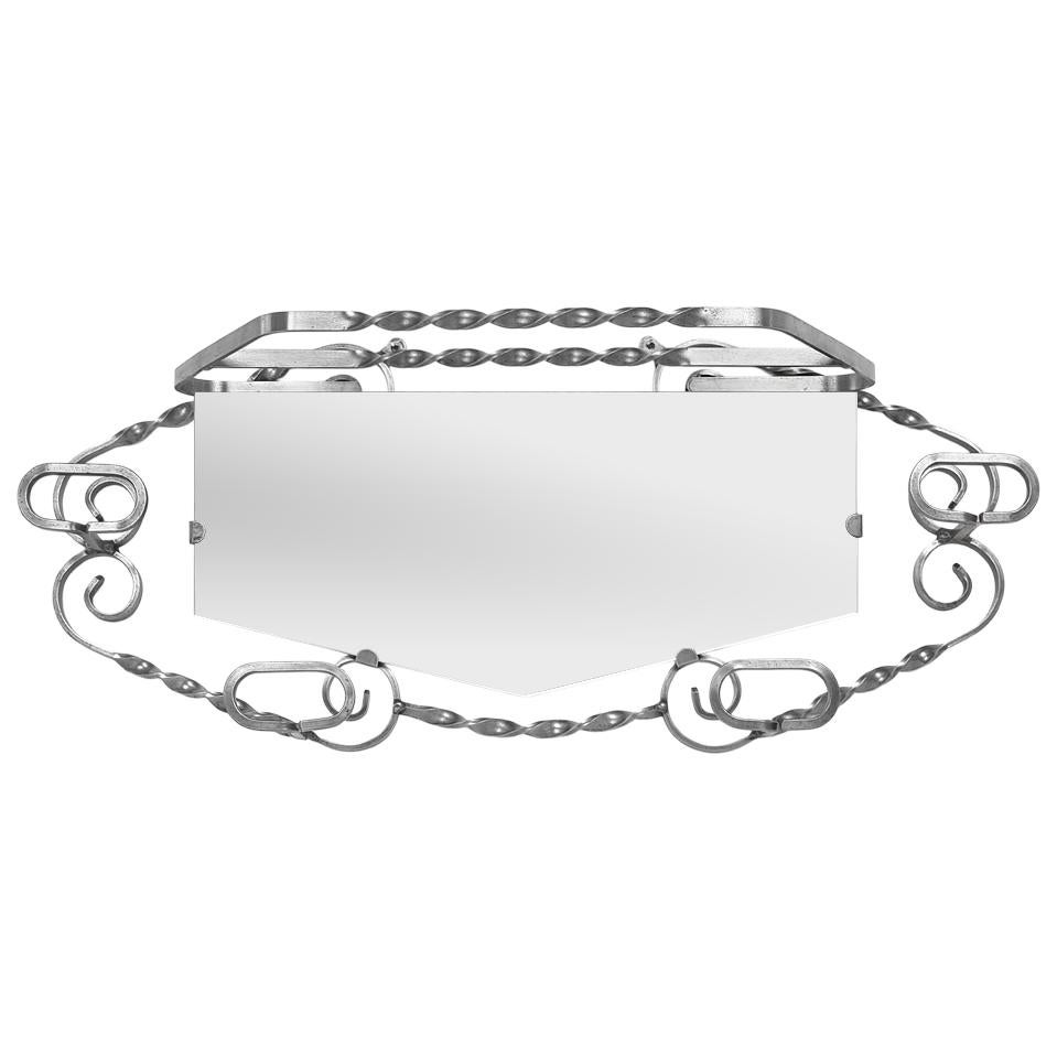 Ce porte-manteau mural ancien, fabriqué en France, allie fonctionnalité et élégance. Datant des années 1950, cet ensemble décoratif en fer forgé combine un miroir central à cinq faces (en verre moderne pour un reflet parfait) et quatre crochets