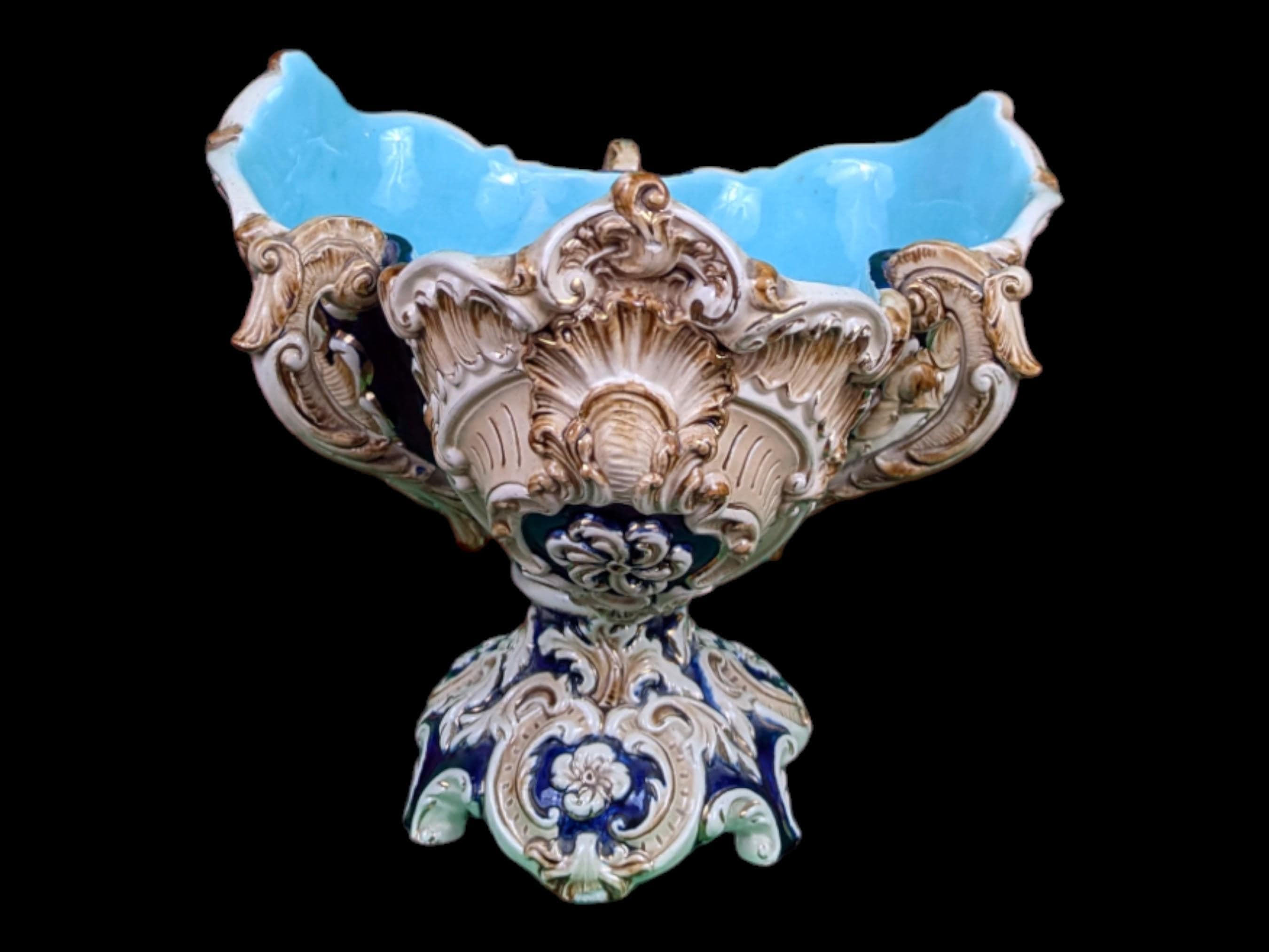 This exquisite 19th-century Austrian Majolica clover-shaped bowl is a true testament to the artistry and craftsmanship of the period. Carefully hand-molded and painted, the bowl features an elegant three-lobed clover design, symbolizing both luck