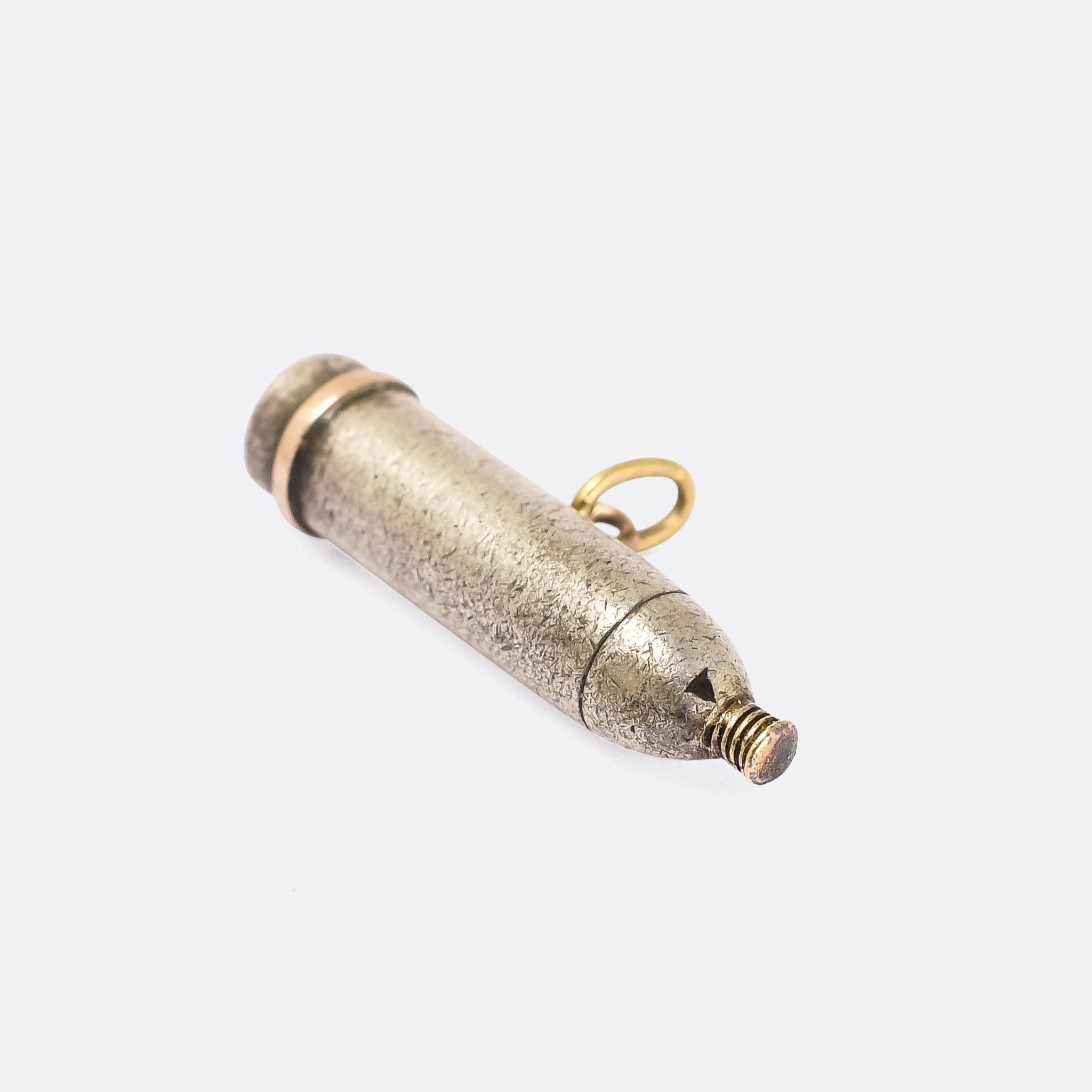 An unusual antique pendant modelled as a WW1 artillery shell. It's crafted in silver with gold fittings and details, with French marks and the date 1915 inscribed on the base. It's particularly well made, with strong attention to