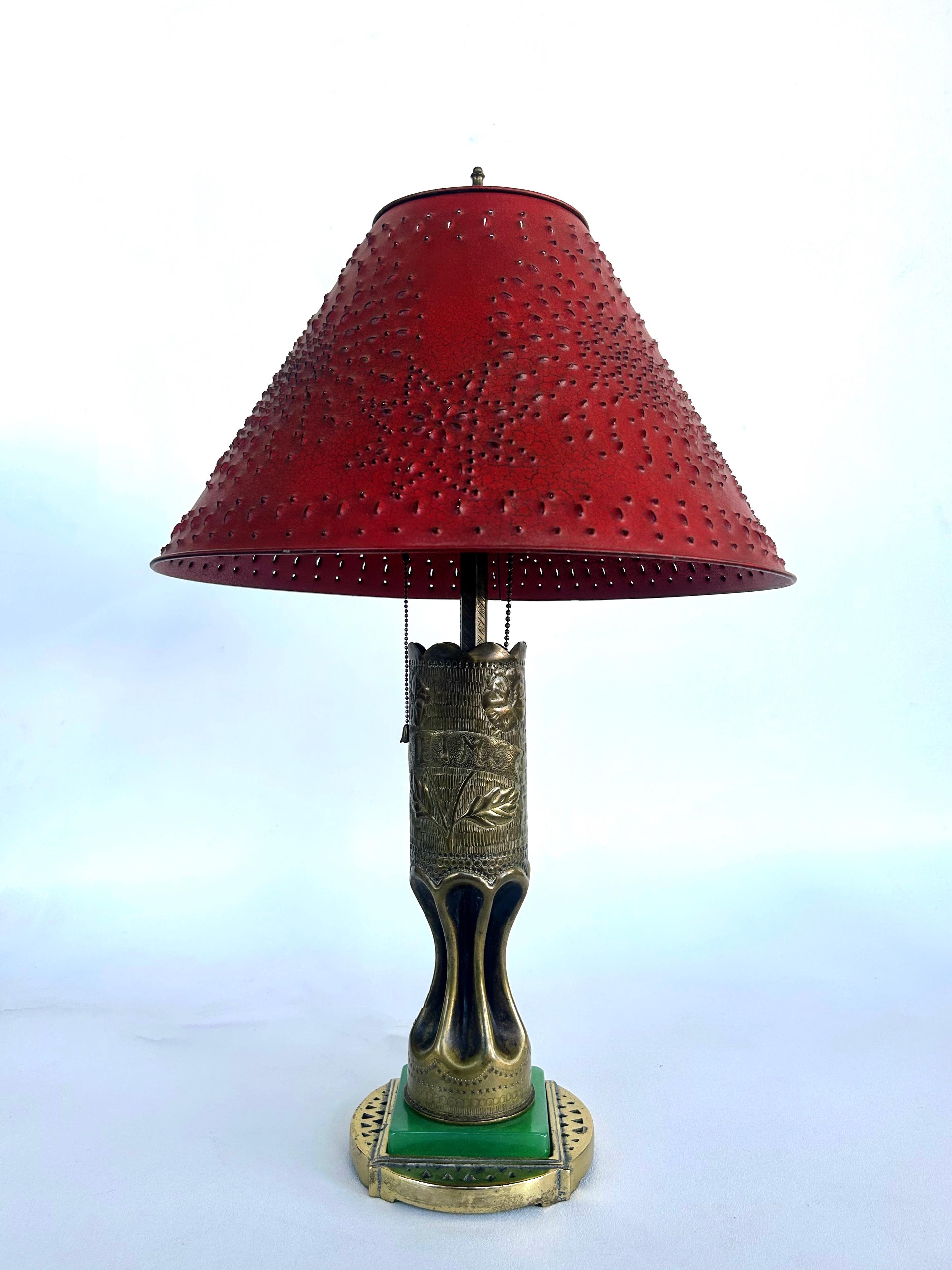 Antique WWI Trench Art Engraved Brass Artillery Shell Table Lamp 

Offered for sale is a unique and interesting antique World War One engraved brass artillery shell mounted upon a plinth of jade-colored glass and mounted as a table lamp.  The lamp