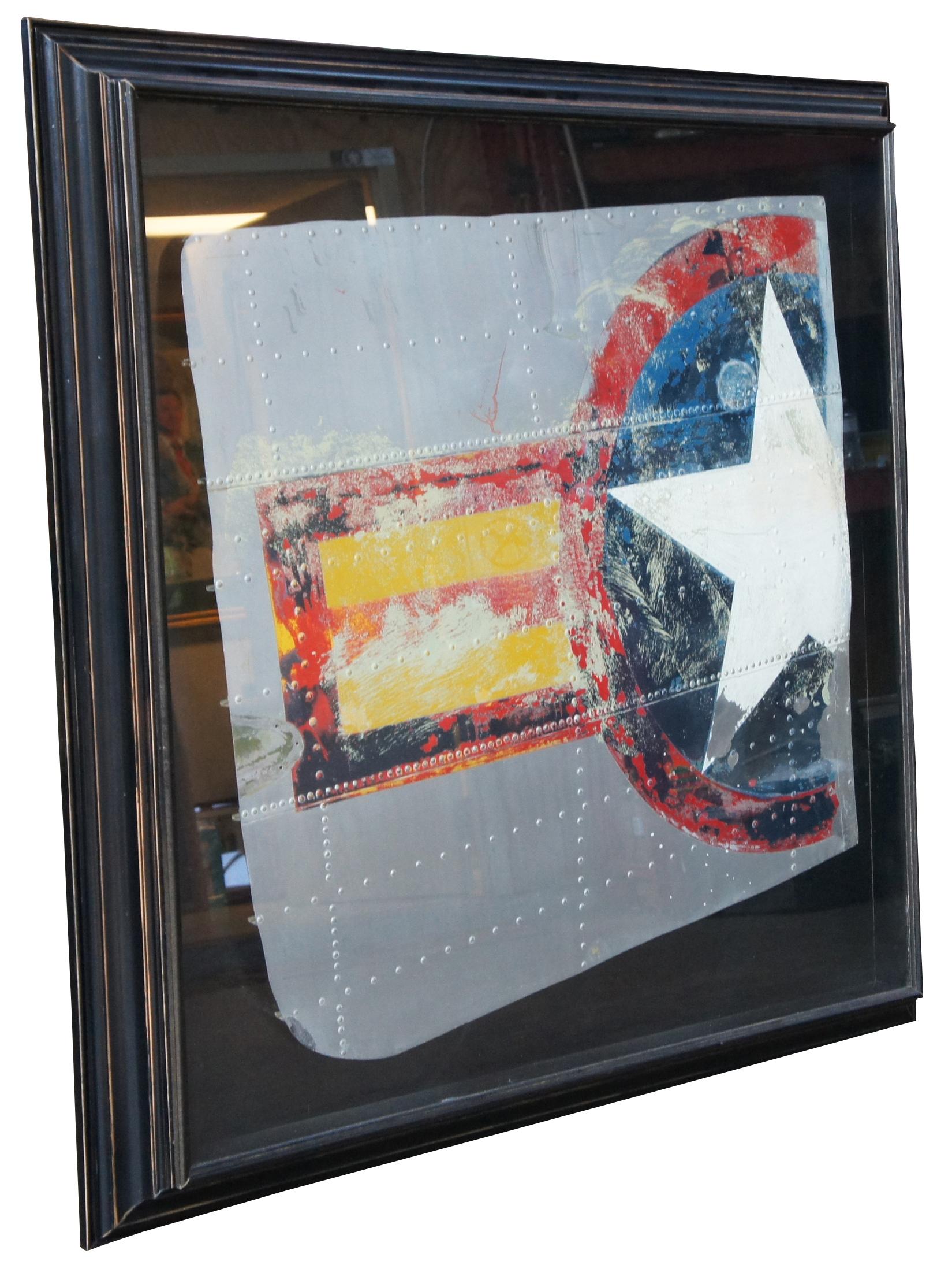 Antique World War II era United States Army Air Force airplane fuselage segment, mounted in a shadowbox frame and featuring the stars and bars decal insignia.

Sans Frame - 40” x 39”