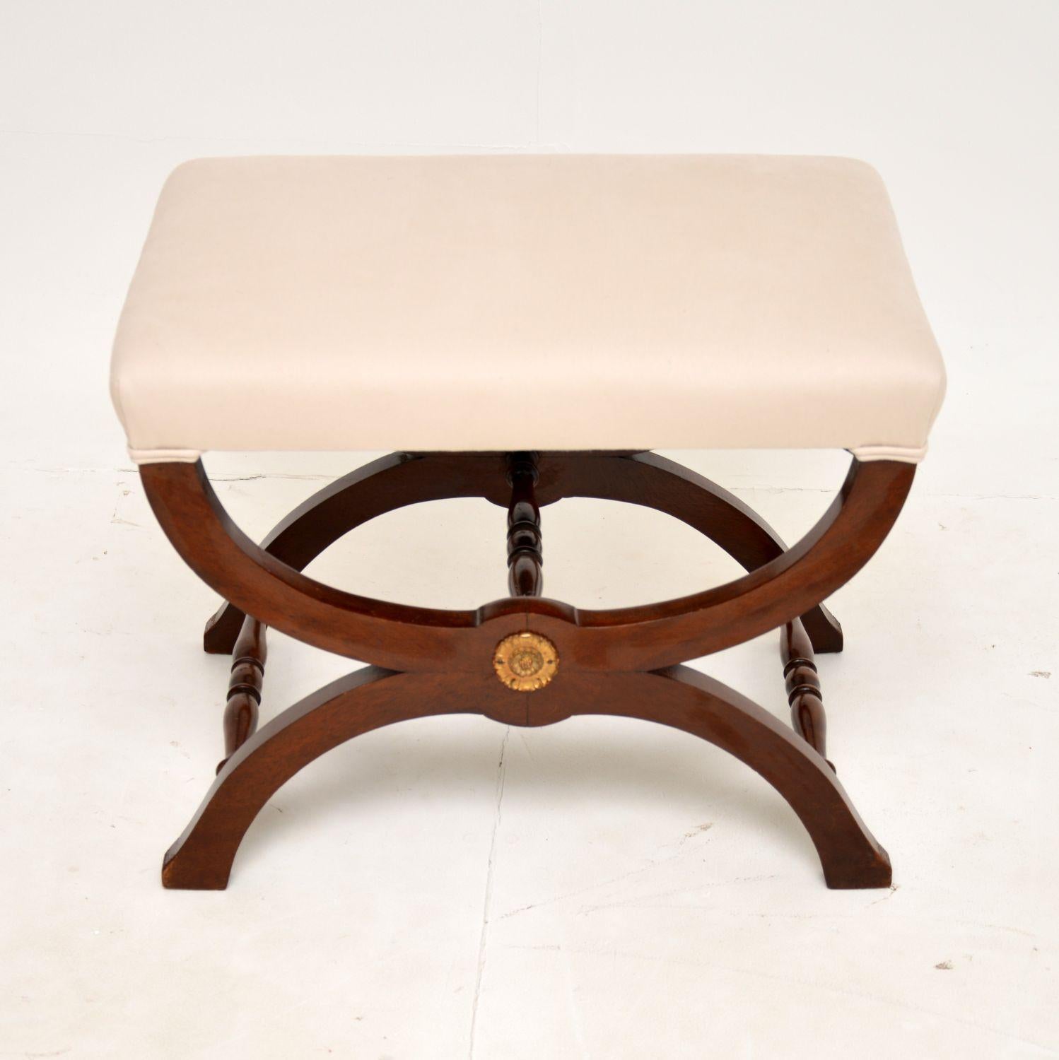 A lovely antique Regency style X framed stool. This was made in England, it dates from around the 1930’s period.

It is a very useful size and is very well made. The X frame design has three stretchers for extra stability, and there is a gilt metal