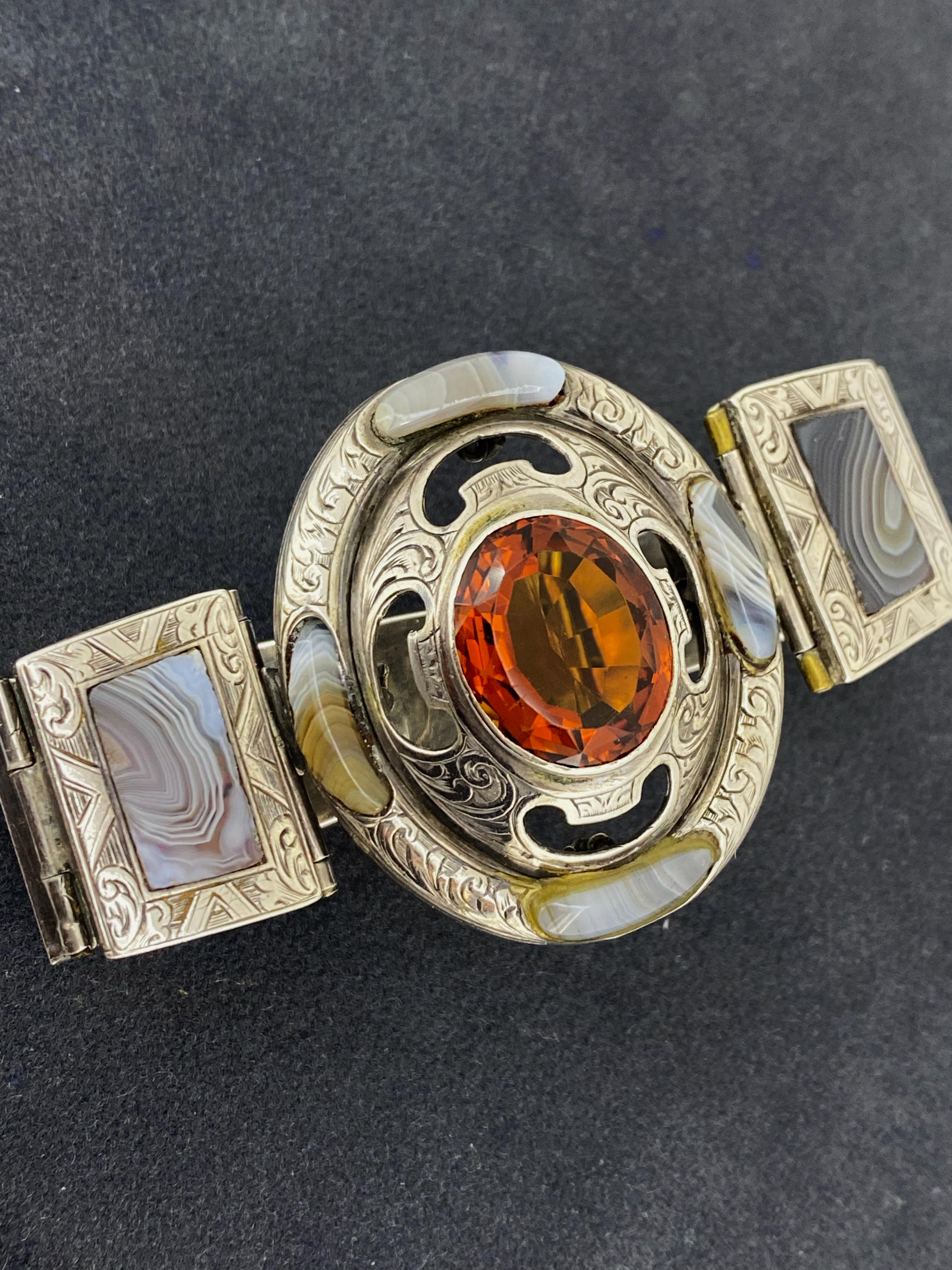 This fine & rare piece of jewellery is 

an Antique Scottish Link Bracelet, 

dating from late XIX century  

 

Crafted in Silver, 

the piece is centrally set with a Natural Oval Citrine

of Madeira type, of fiery orange colour,

of impressive