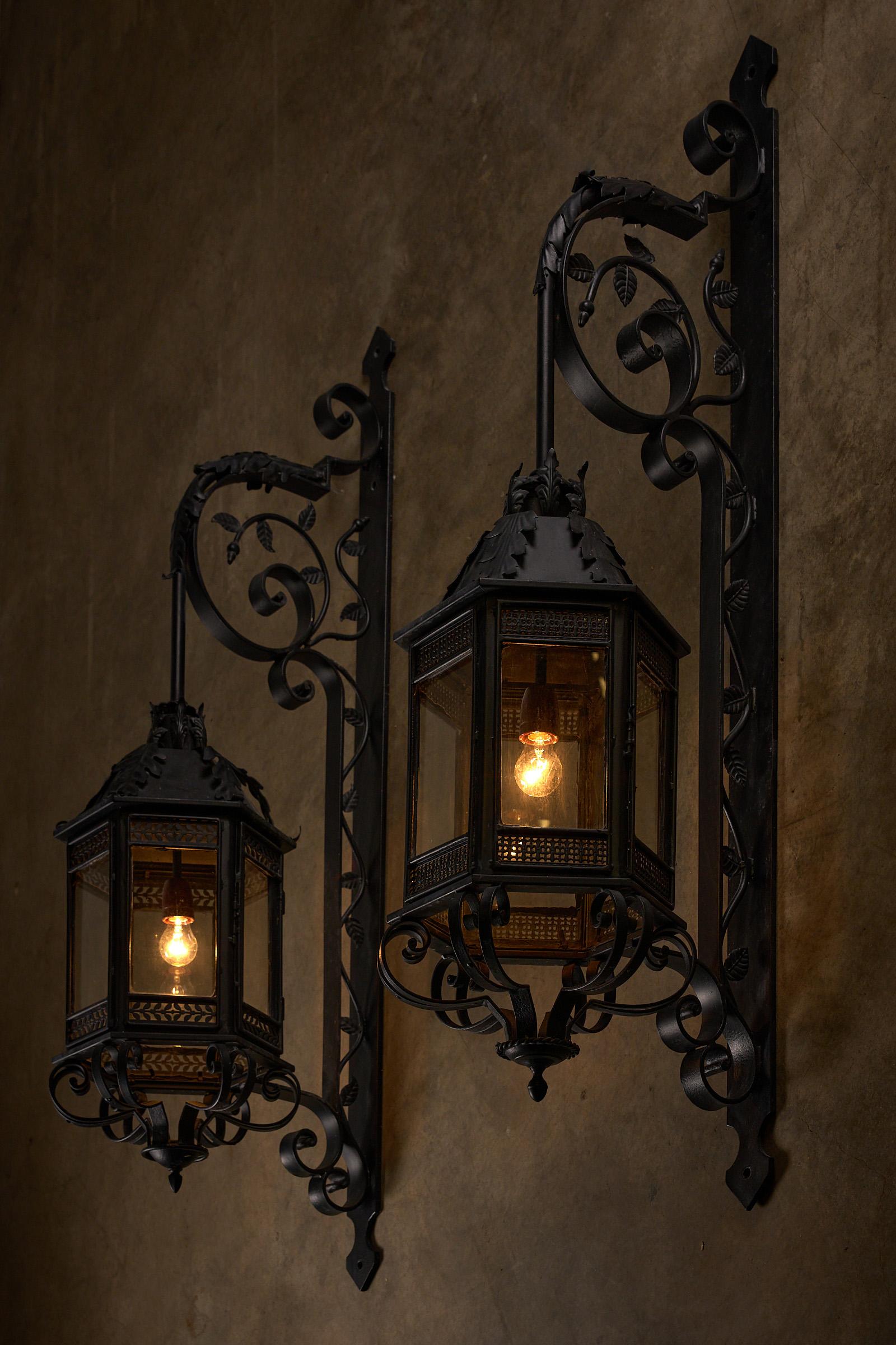 This striking set of two XL outdoor wall lanterns, crafted from wrought iron, originates from an old building in the Netherlands. With an impressive height of 150 cm, these lanterns are a larger size, making them a remarkable and elegant feature for