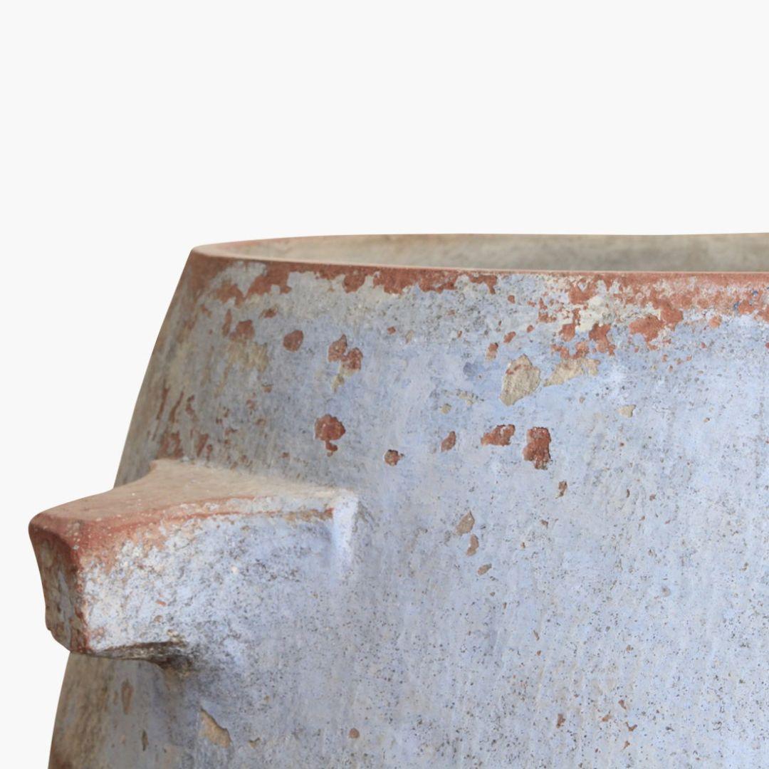 This vintage stone water reservoir pot from India, often referred to as a 