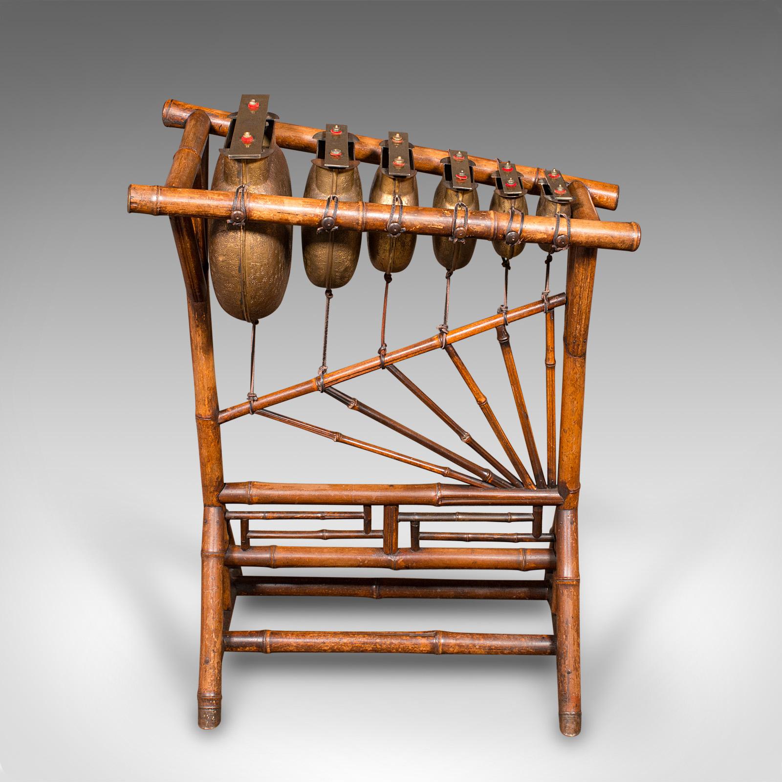 This is an antique Harmonicon xylophone. An English, bronze and bamboo framed musical instrument by W.F. Needham of Birmingham, dating to the late Victorian period, circa 1900.

Striking Chinoiserie taste to the frame, with superb