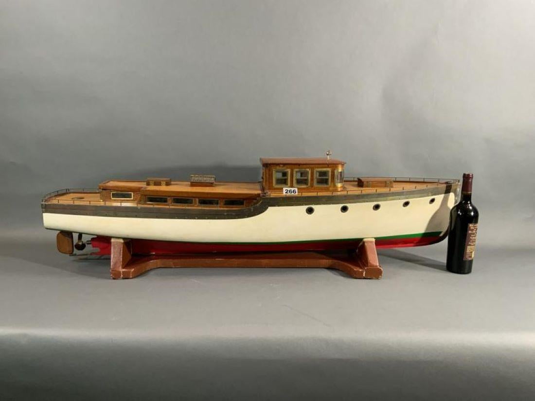 Motor yacht model circa 1925. This model of a motor yacht is built to a large scale and shows exceptional detail. The model has extensive brass trim, planked decks, mahogany trim, portholes, prop, rudder, etc.

Overall dimensions: Weight is 29