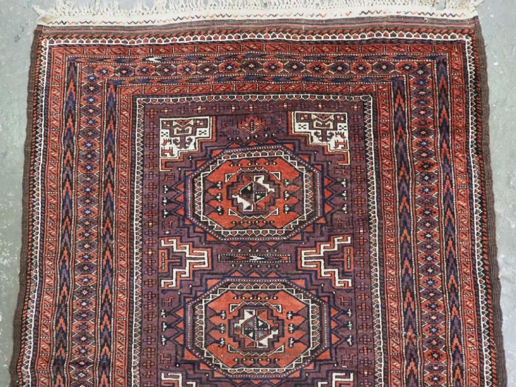 Asian Antique Yaqoub Khani Baluch Rug, Octogen Design On Aubergine Ground, Circa 1900 For Sale