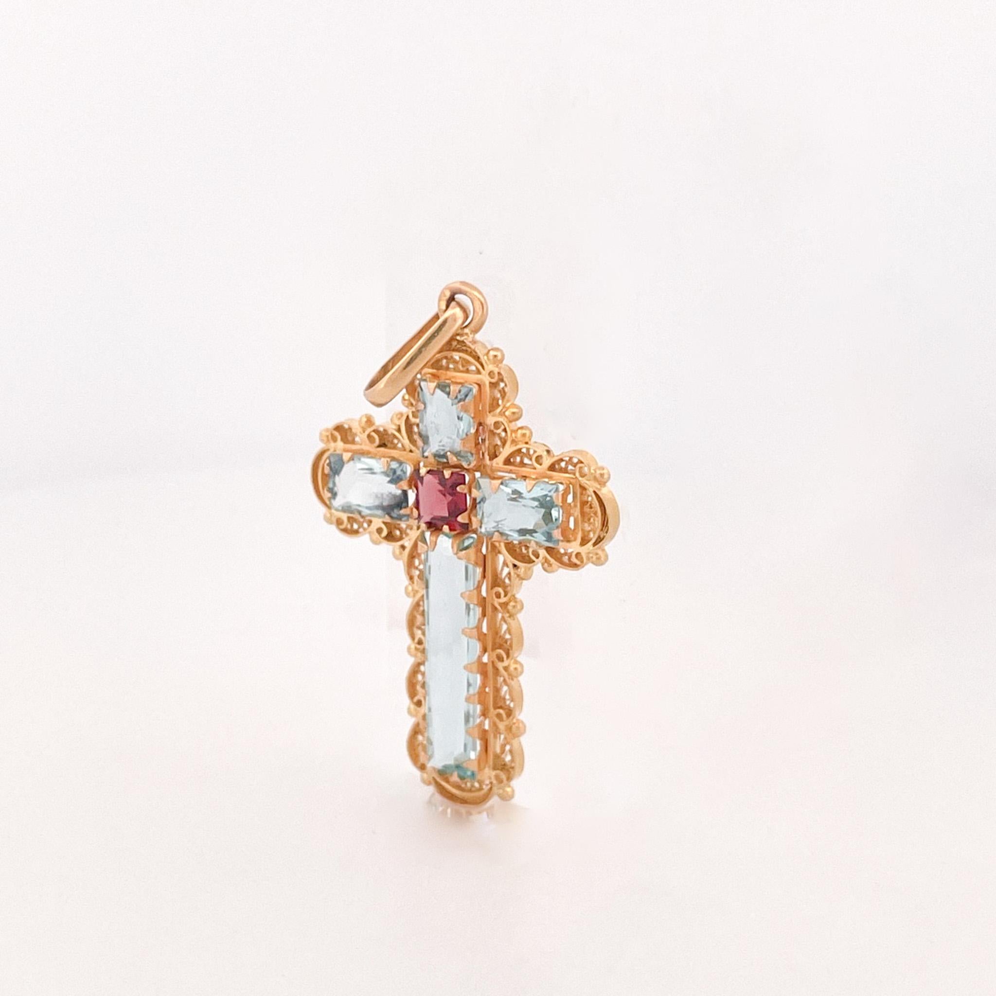 From the Eiseman Estate Jewelry Collection, yellow gold aquamarine antique cross pendant. This pendant is crafted with 4 aquamarine stones accented by yellow gold scroll work. This pendant measures 2 inches in length and features a single bail. This