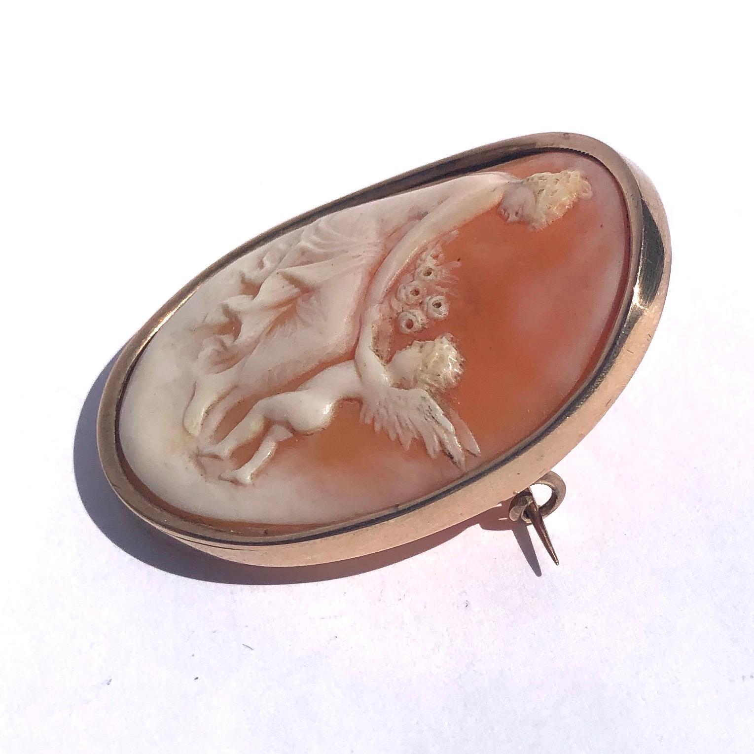 The sweet image on this delicately carved cameo brooch is of a cherub gifting flowers to a lovely lady. The brooch is slightly curved which really makes the image stand out. 

Dimensions: 41x31mm 

Weight: 9.4g