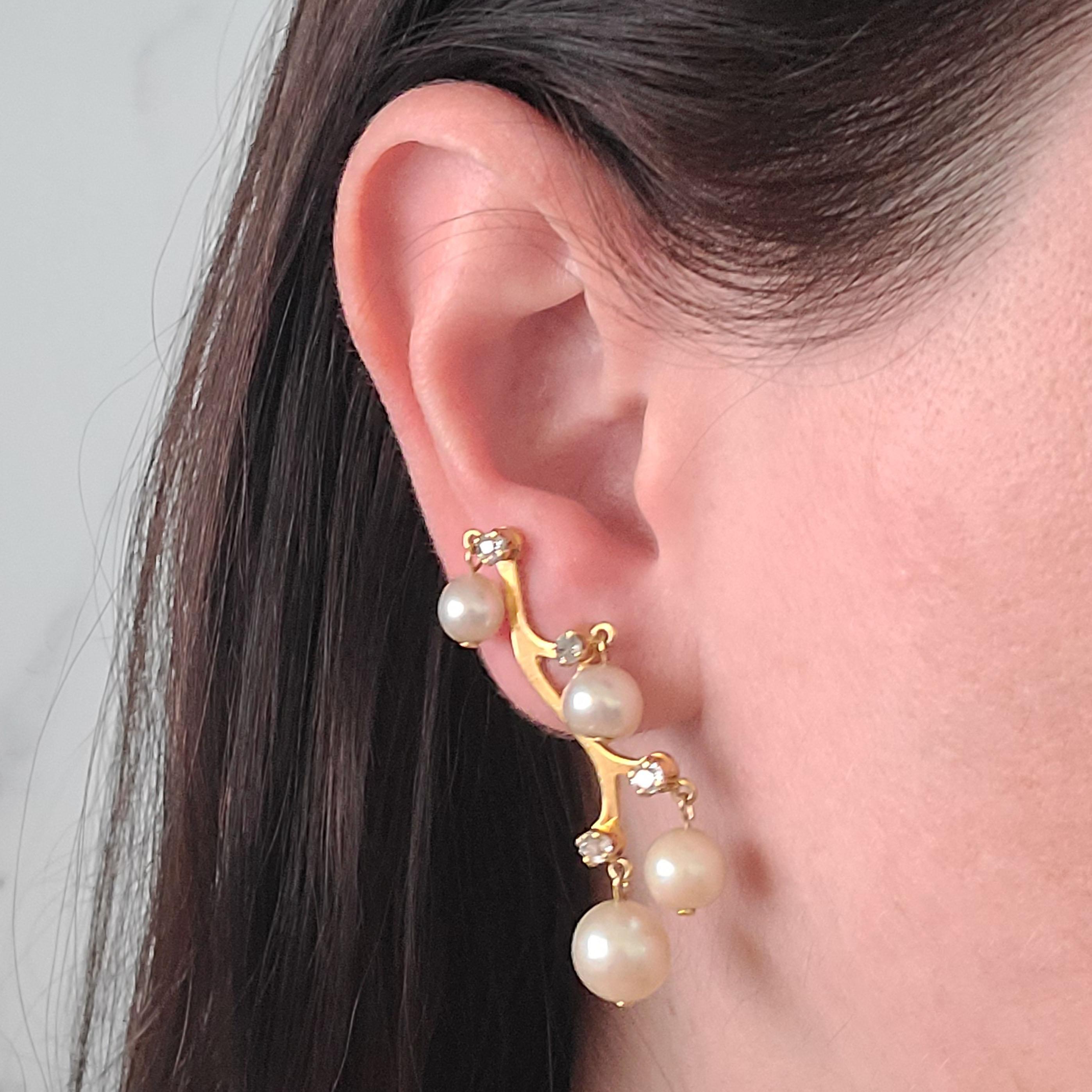 18 Karat Yellow Gold Antique Earrings Featuring 8 Dangling Cultured Saltwater Pearls and 8 Old Mine Cut Diamonds Totaling 0.50 Carats. Ear Crawler Design with Unpierced Screwback Closure; Can Convert To Pierced Post Upon Request. 2 Inch Length.