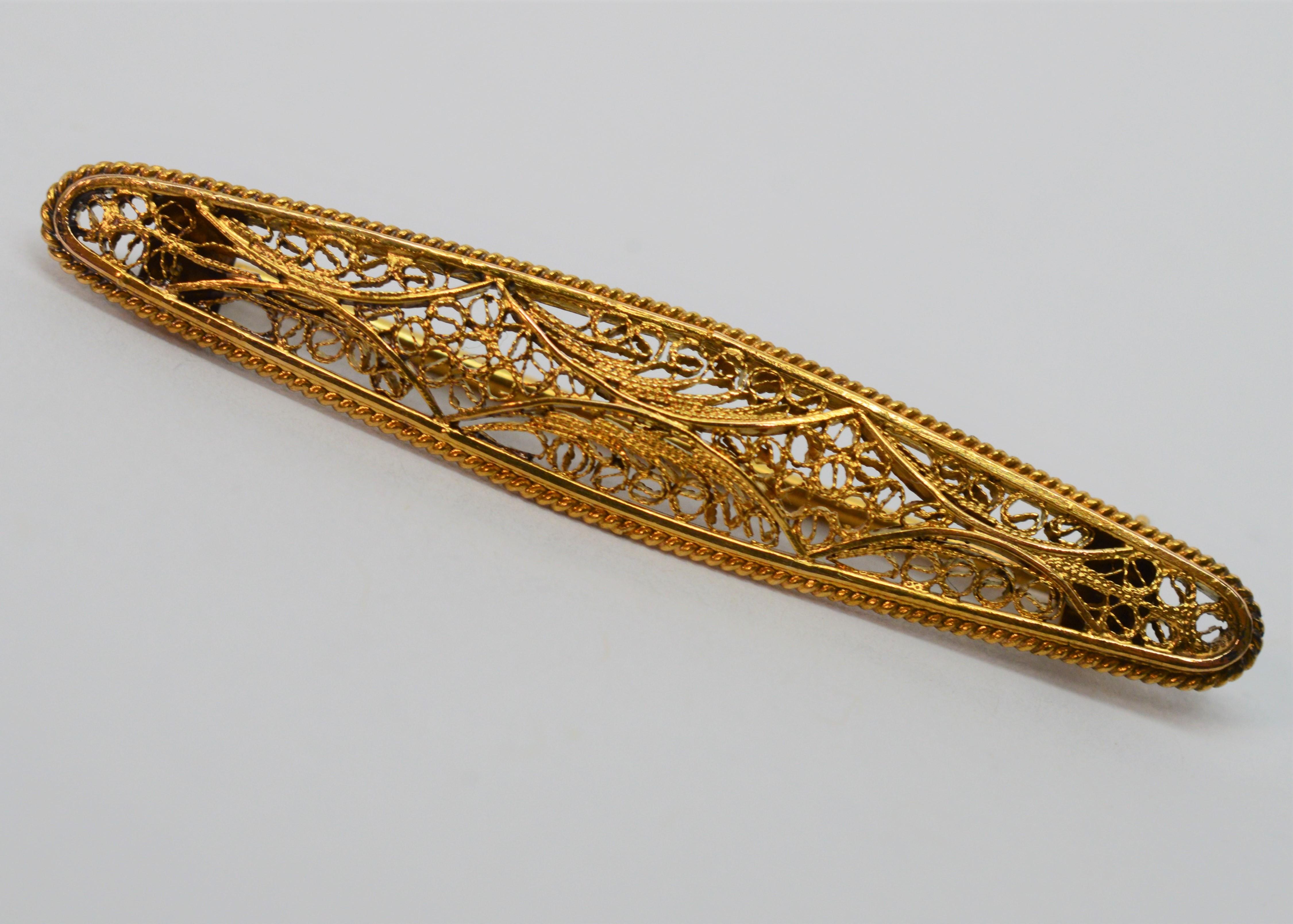 Accent a lapel, scarf or collar with this sweet antique intricate filigree bar pin made of eighteen karat 18K yellow gold .
Measures 1-7/8  inches long and 3/8 inch at its widest point. Fitted with period correct rollover clasp. Gift boxed.  