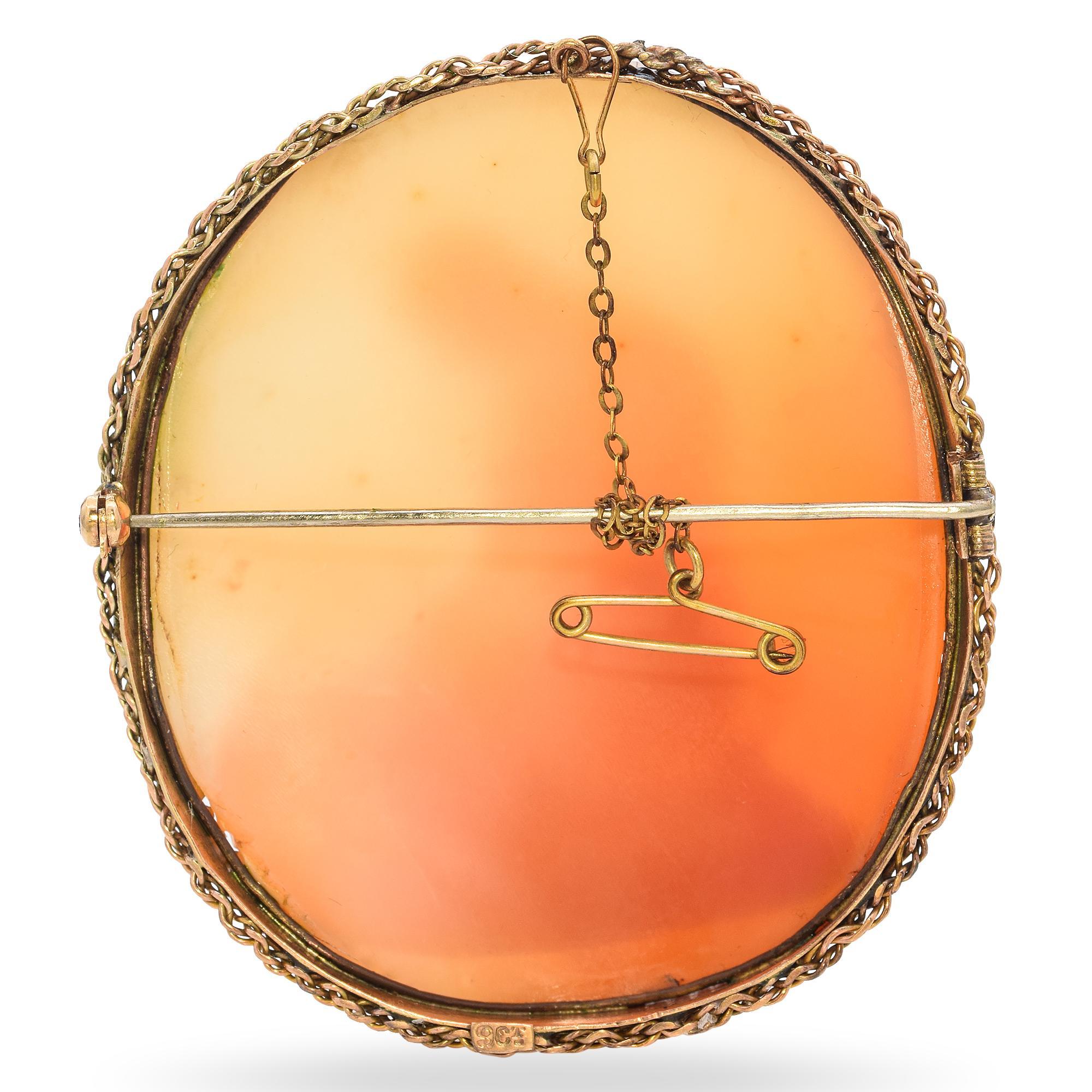 This evocative antique brooch features a finely carved image of Mary Magdalen in repentance, portrayed with downcast eyes and flowing hair, often associated with sorrow and redemption. Set in a warm yellow gold frame, the piece blends spiritual