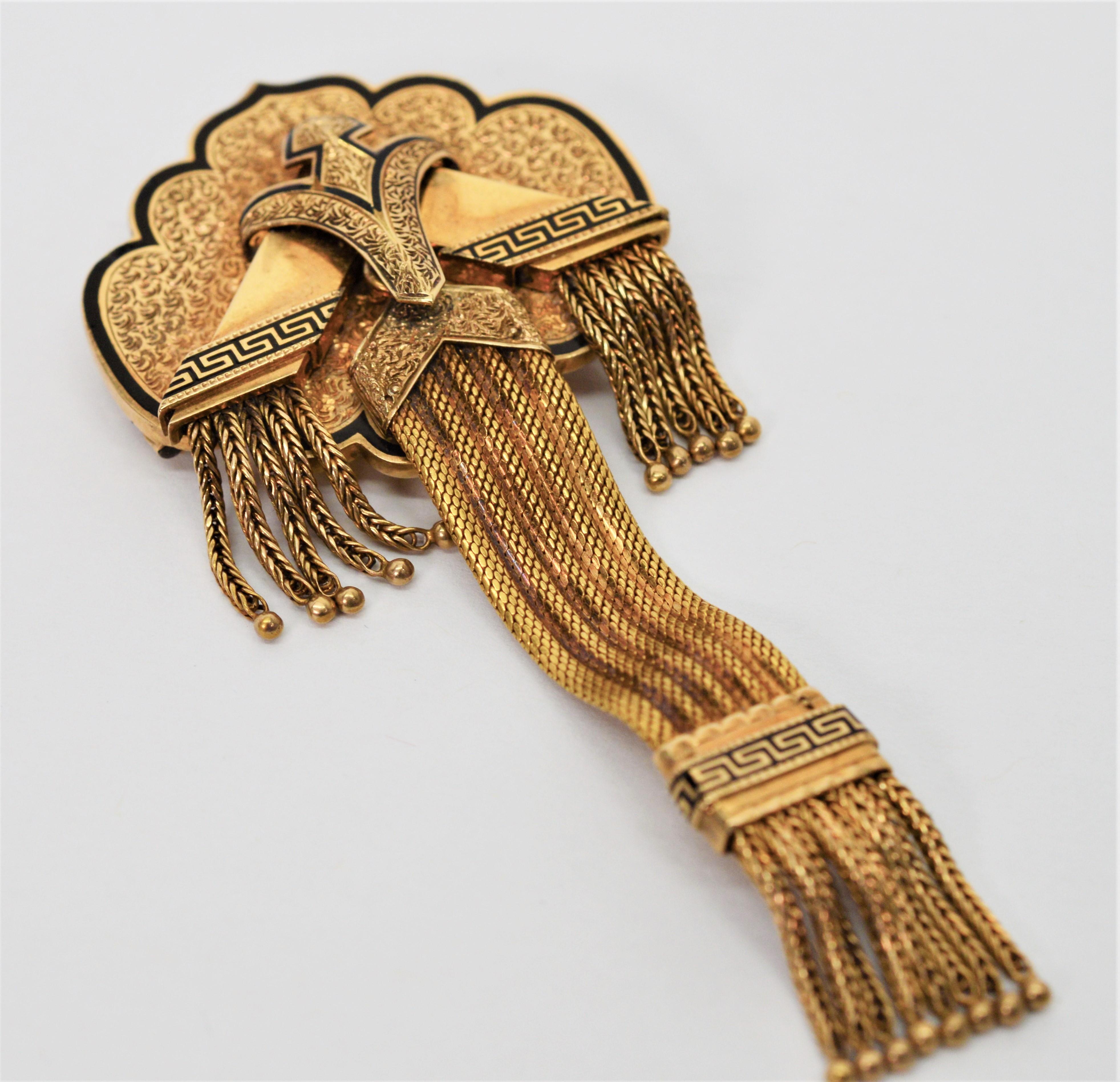 In fourteen carat yellow gold and looking very regal with braided tassels and black enamel accents, this Civil War era pin brooch makes a unique
accessory to a blazer or lapel.  Artfully hand engraved and crafted with three dimensions, the use of