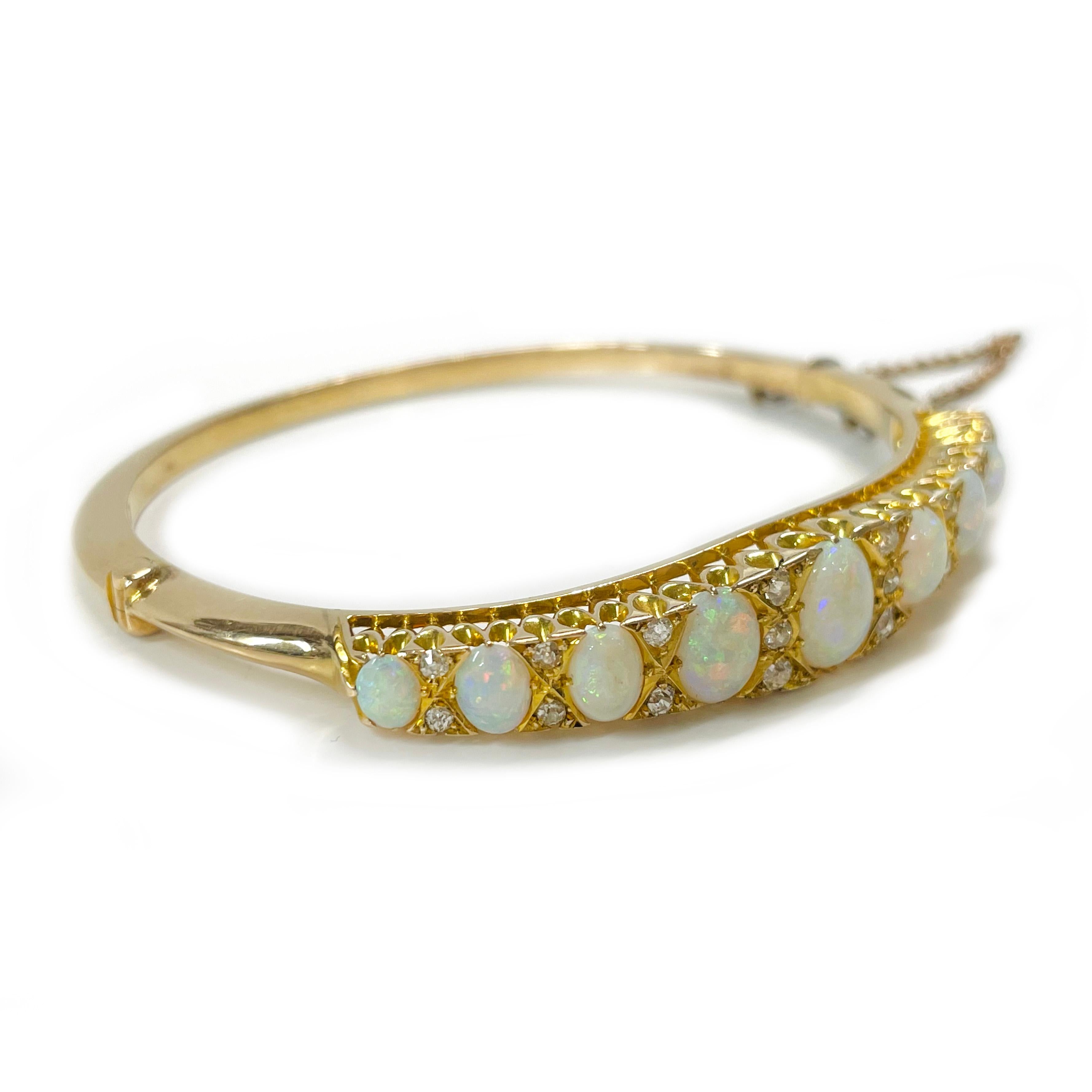 Tested 18 Karat Yellow Gold Opal Diamond Hinged Bangle Bracelet. Nine prong-set Opals and eighteen euro-cut diamonds adorn this lovely bangle bracelet. The carat total weight of the AA quality Opals is 3.66ctw. The white Opals have a play of color