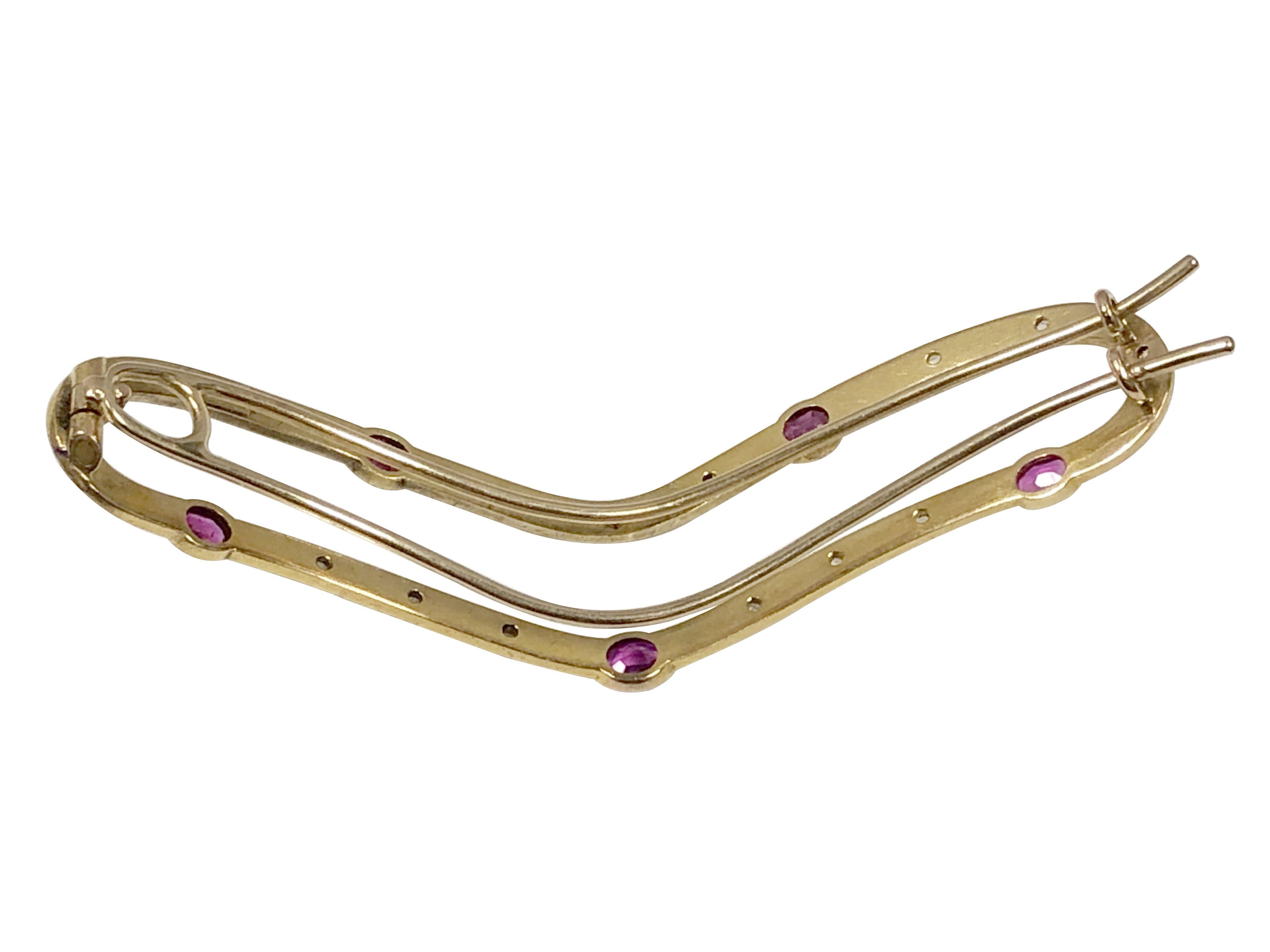 Circa 1900 14k Yellow Gold Hair Barrett, measuring 3 inches in length and 3/4 inch wide, having a Hand Hammered finish, set with Rose cut Diamonds and Fine Color Oval Rubies. 
