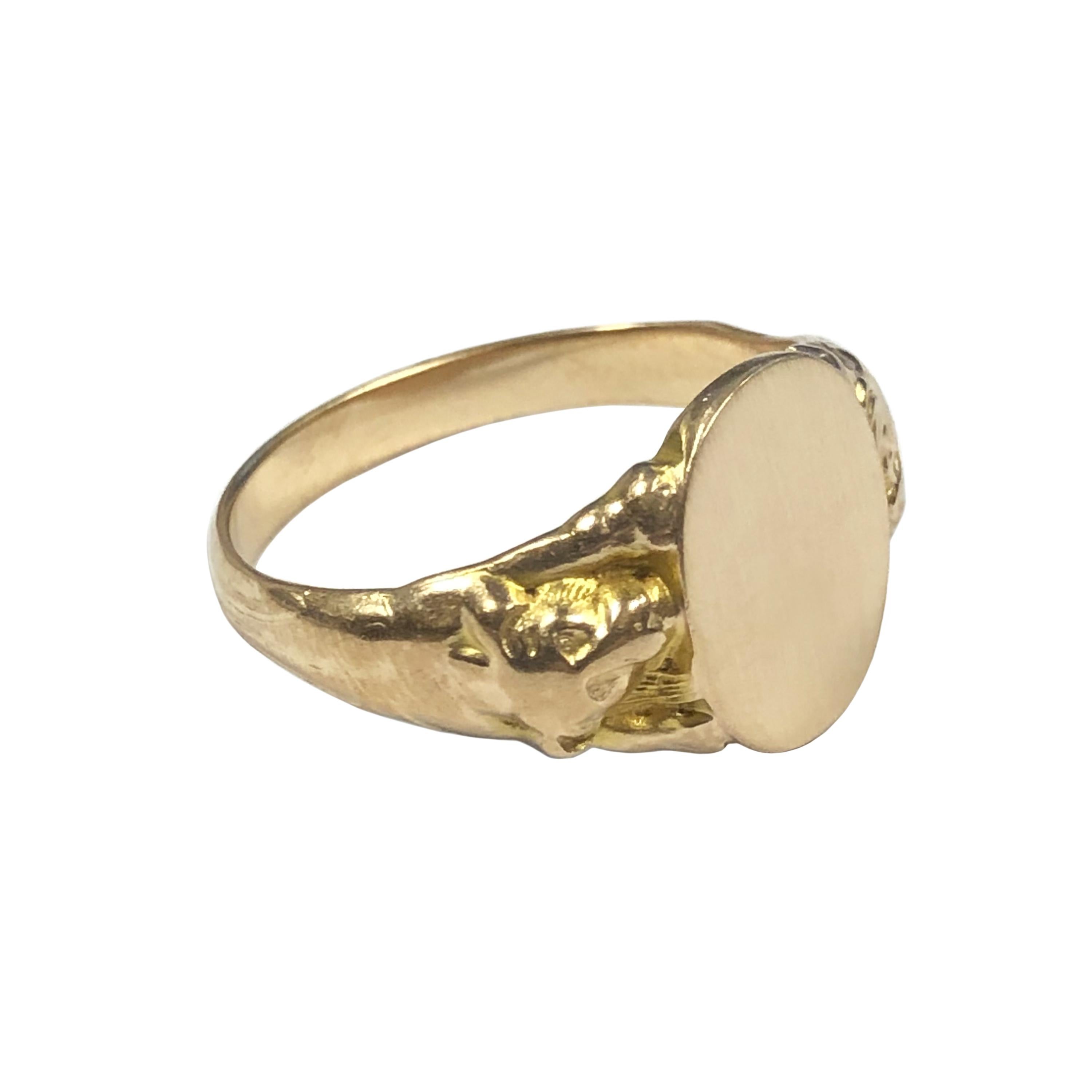 Circa 1910 14K Yellow Gold Art Nouveau Signet Ring, the top of the ring measures 9/16 X 7/16 inch, the sides of the ring have raised lions that hold up the center signet section. Finger size 10 1/2. 