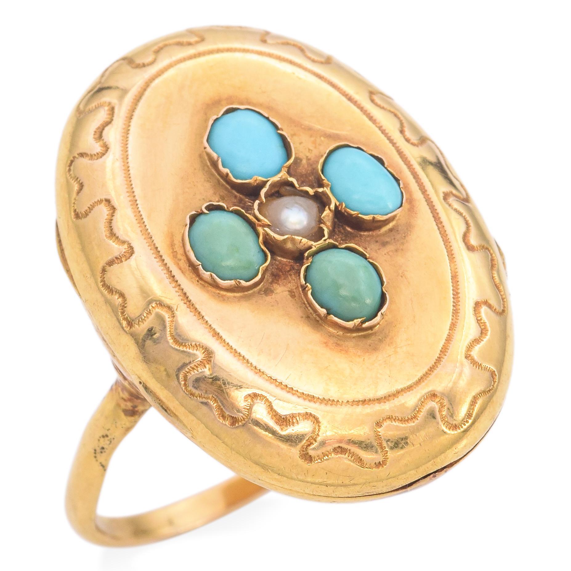 This captivating piece, crafted in rich gold, features a harmonious arrangement of vibrant turquoise stones and a central lustrous pearl.
The intricate design showcases a textured gold surface, adorned with delicate engravings that frame the