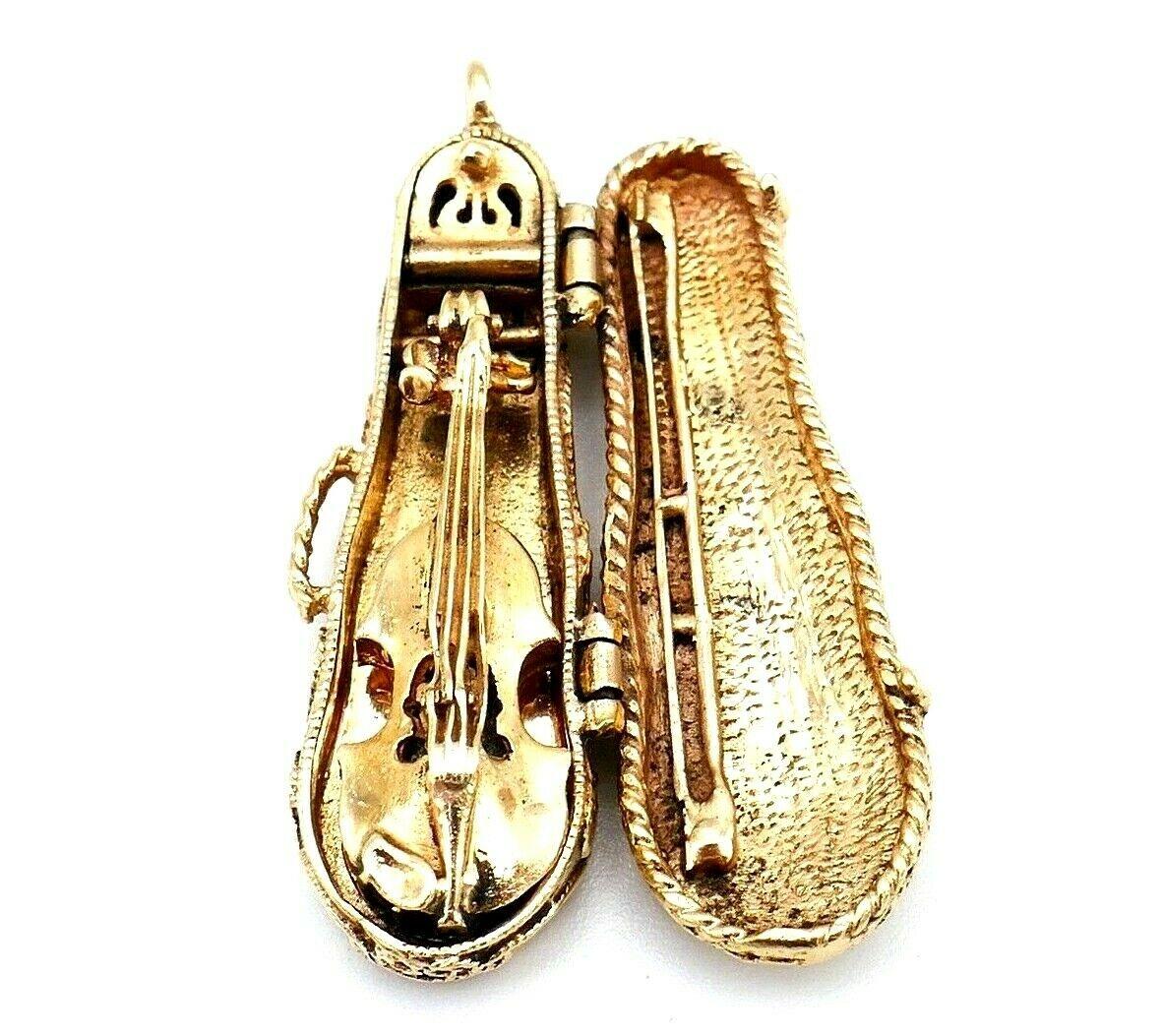 Adorable antique 14k yellow gold violin charm featuring turquoise and Peking glass beads. The violin is attached inside the case, it's mechanical (see the pics). 
The case's details are incredible: it has latches, a handle, a pocket for 