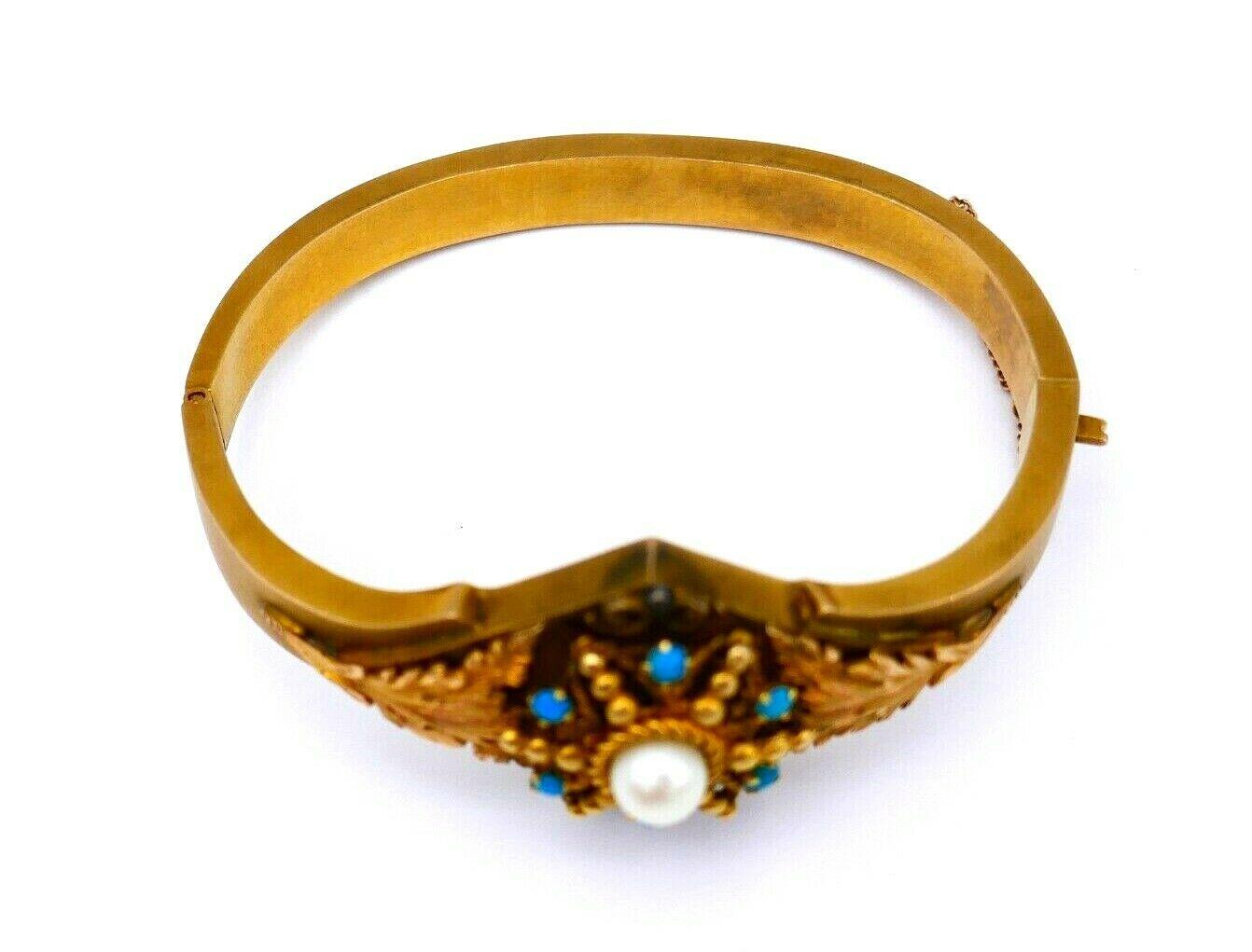 A beautiful antique bangle bracelet made of 14k yellow gold, pearl and turquoise. The ornament part features textured leafy gold elements and gold beads. 
Stamped with maker's mark and a hallmark for 14k gold.
Measurements: inner circumference is