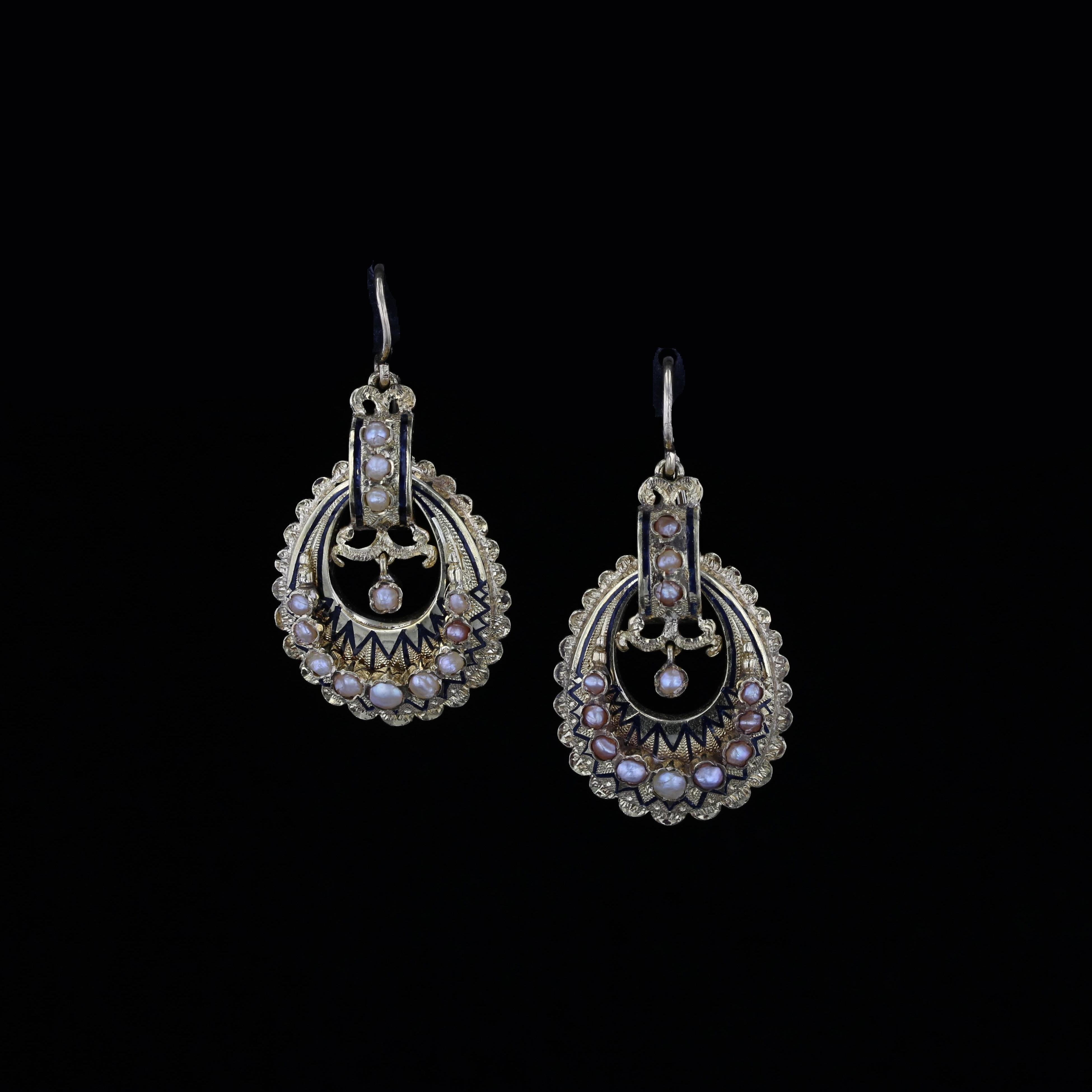 This pair of 15k yellow gold earrings from the Victorian Era - crafted circa 1880 - are a true treasure. Featuring black enamel detailing and creamy pink pearls that come together to create an elegant contrast of funky and sweet.