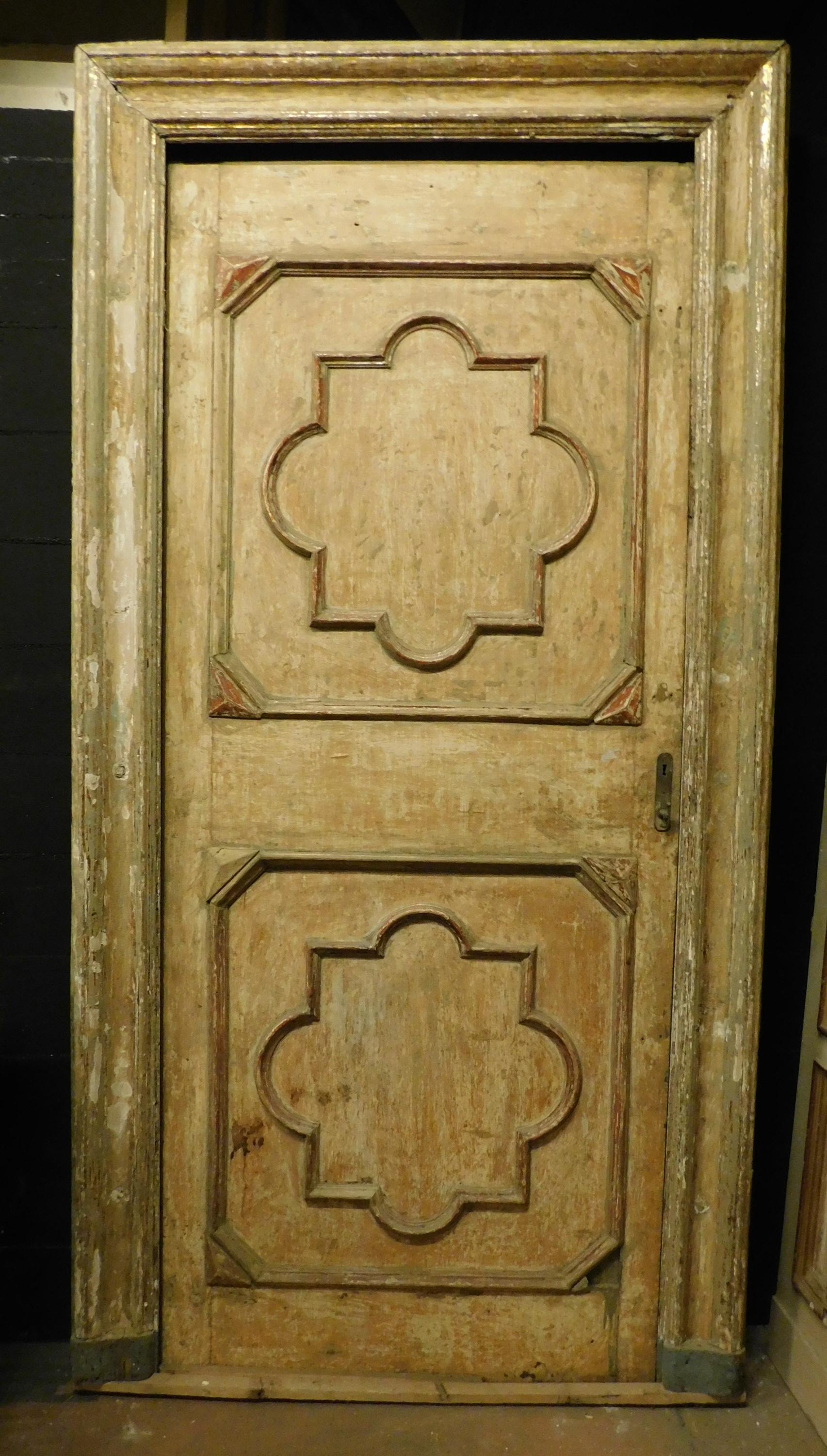 Ancient yellow lacquered door, sculpted with typical tiles of the time and complete with original frame, in original patina, very fascinating, built entirely by hand in the 18th century for an important building in Italy, from Piedmont, size cm W