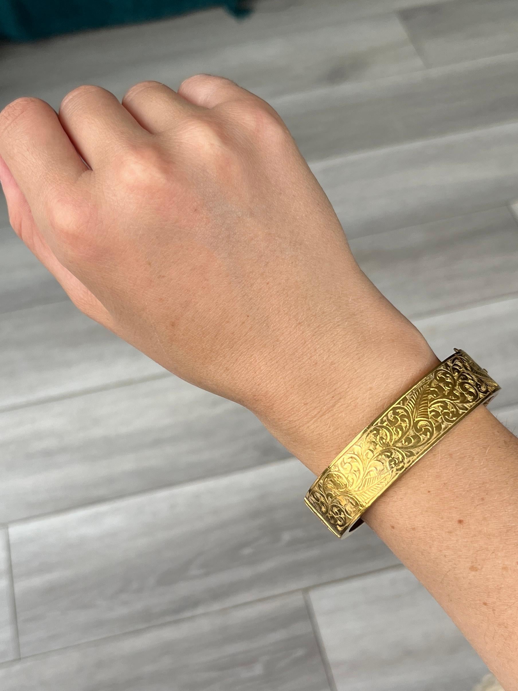 This gorgeous yellow metal bangle has wonderful engraving and also has the words 'MARY K.R CHURCH, THE LODGE, NEWPORT PAGNELL, OVMC-5-4' engraved onto it. 

Inner diameter widest point: 6cm
Inner circumference:  17.5cm
Bangle Width: 16mm

Weight: