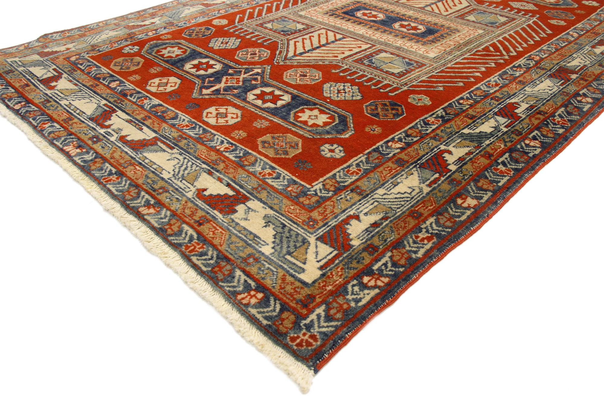 This antique Yerevan rug with modern tribal style displays a mesmerizing geometric pattern in a red field. Rendered in variegated shades of red, blue, beige and brown. Impeccably woven throughout, the rectilinear style border reveals an amazing