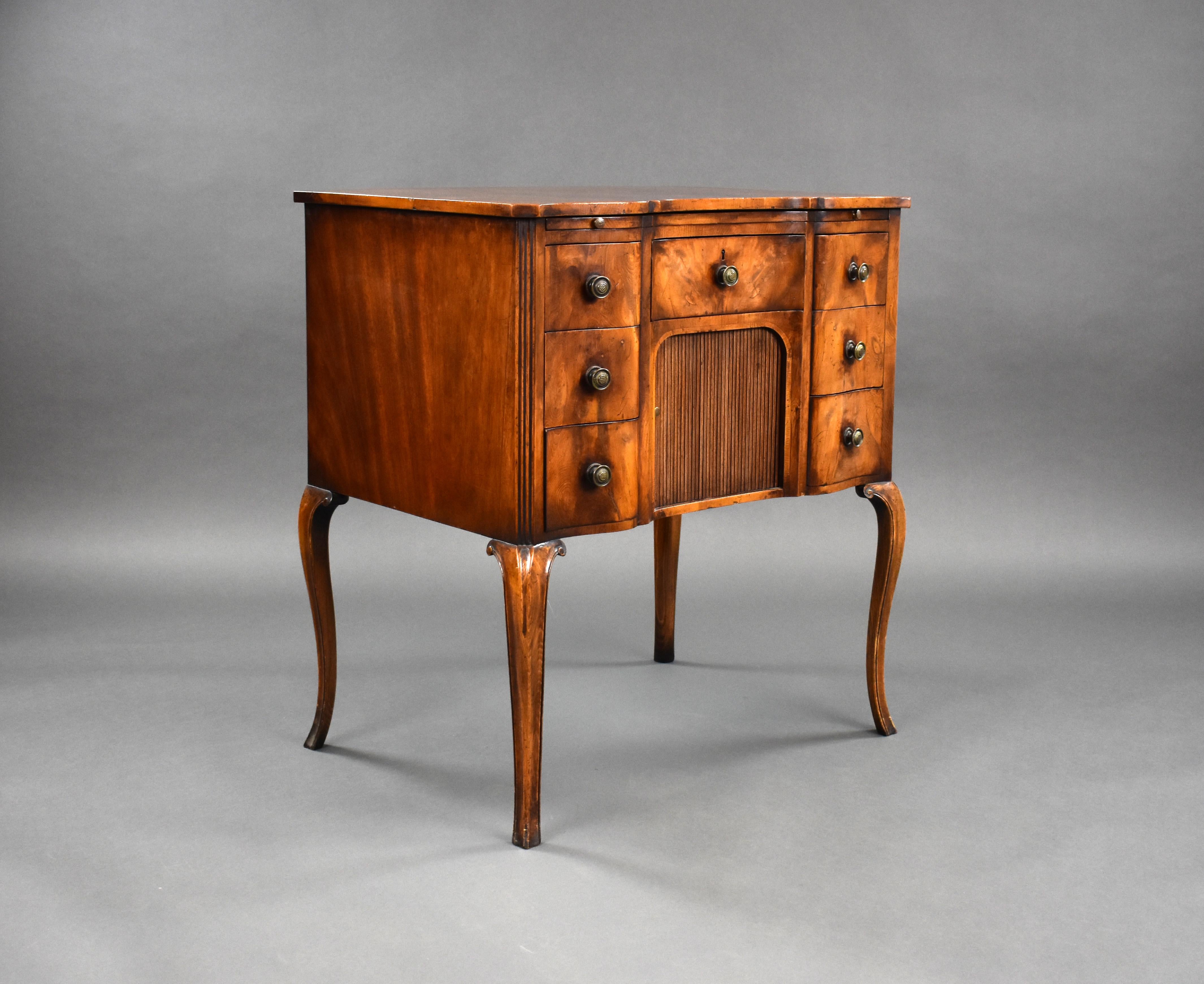A good quality 19th century yew wood chest, serpentine in form, having a writing slide to the top over an arrangement of five drawers surrounding a tambour front. The chest stands on elegantly shaped legs and remains in very good condition for its