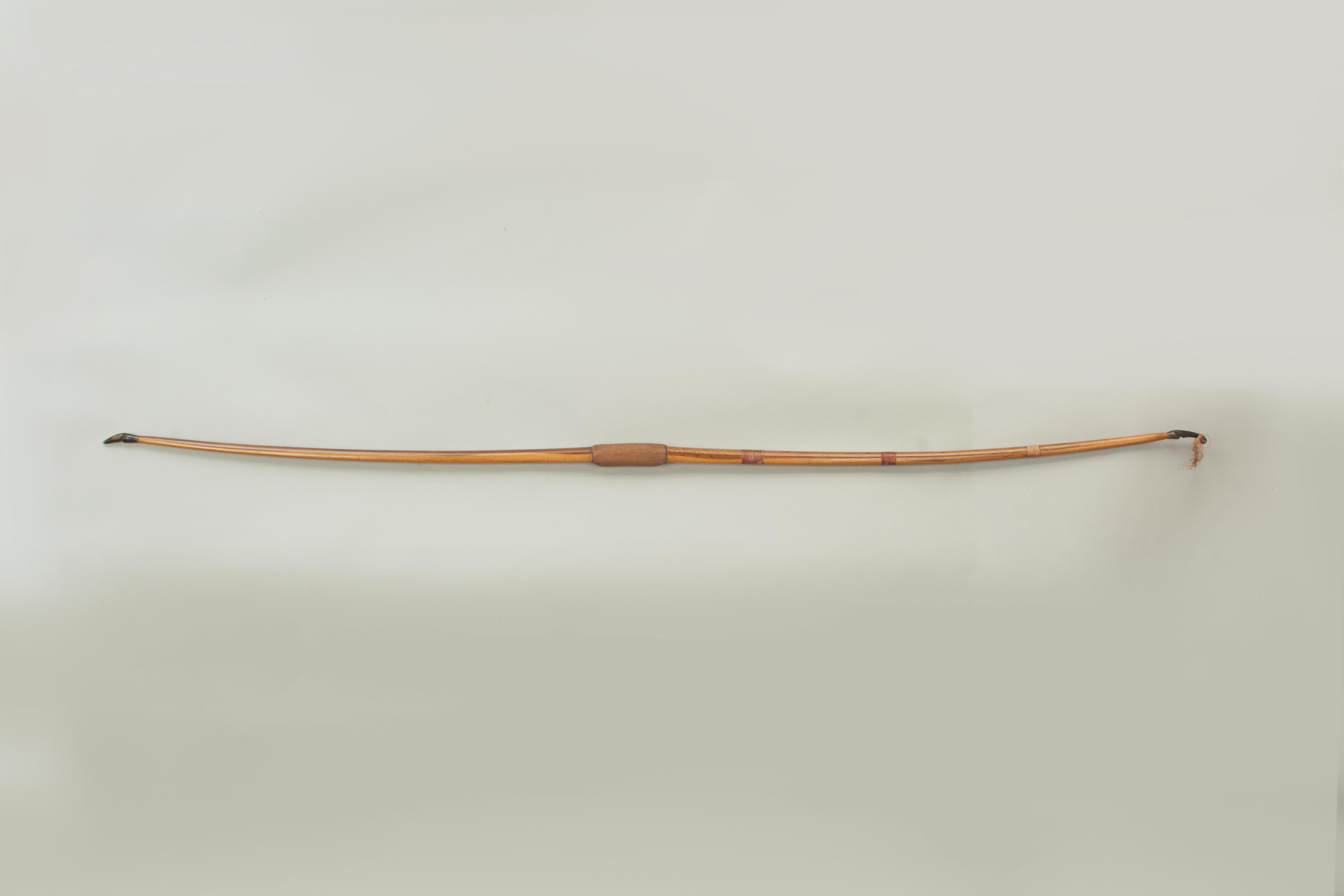 A very nice ladies long bow by Buchanan of Piccadilly.

A very good one piece yew wood archery bow by Buchanan of Piccadilly. The bow is fitted with horn nocks, a mother - of - pearl arrow plate (sometimes called an Arrow Pass)and a rubber handle