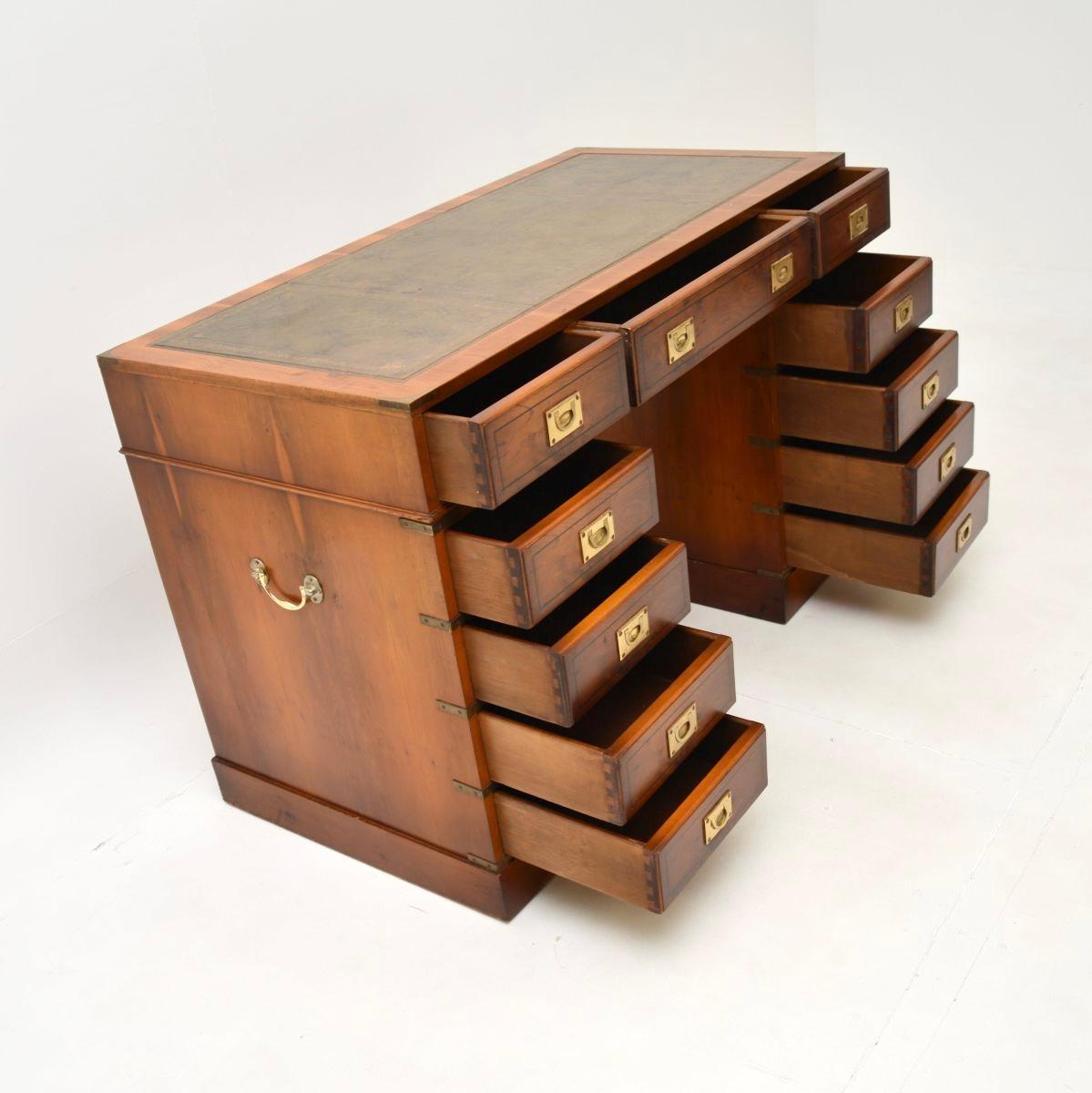 A top quality antique yew wood military campaign style pedestal desk. This was made in England, it dates from around the 1950’s.

It is very well made, with a useful and smart design. The yew wood has a lovely colour tone, there is high quality