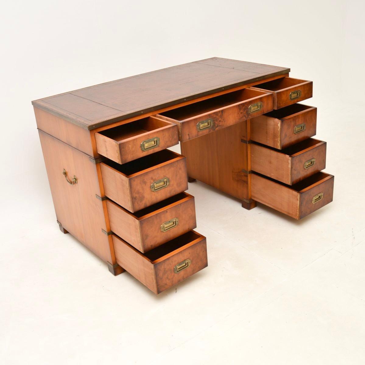 A top quality antique yew wood military campaign style pedestal desk. This was made in England, it dates from around the 1950’s.

It is very well made, with a useful and smart design. The yew wood has a lovely colour tone, there is high quality