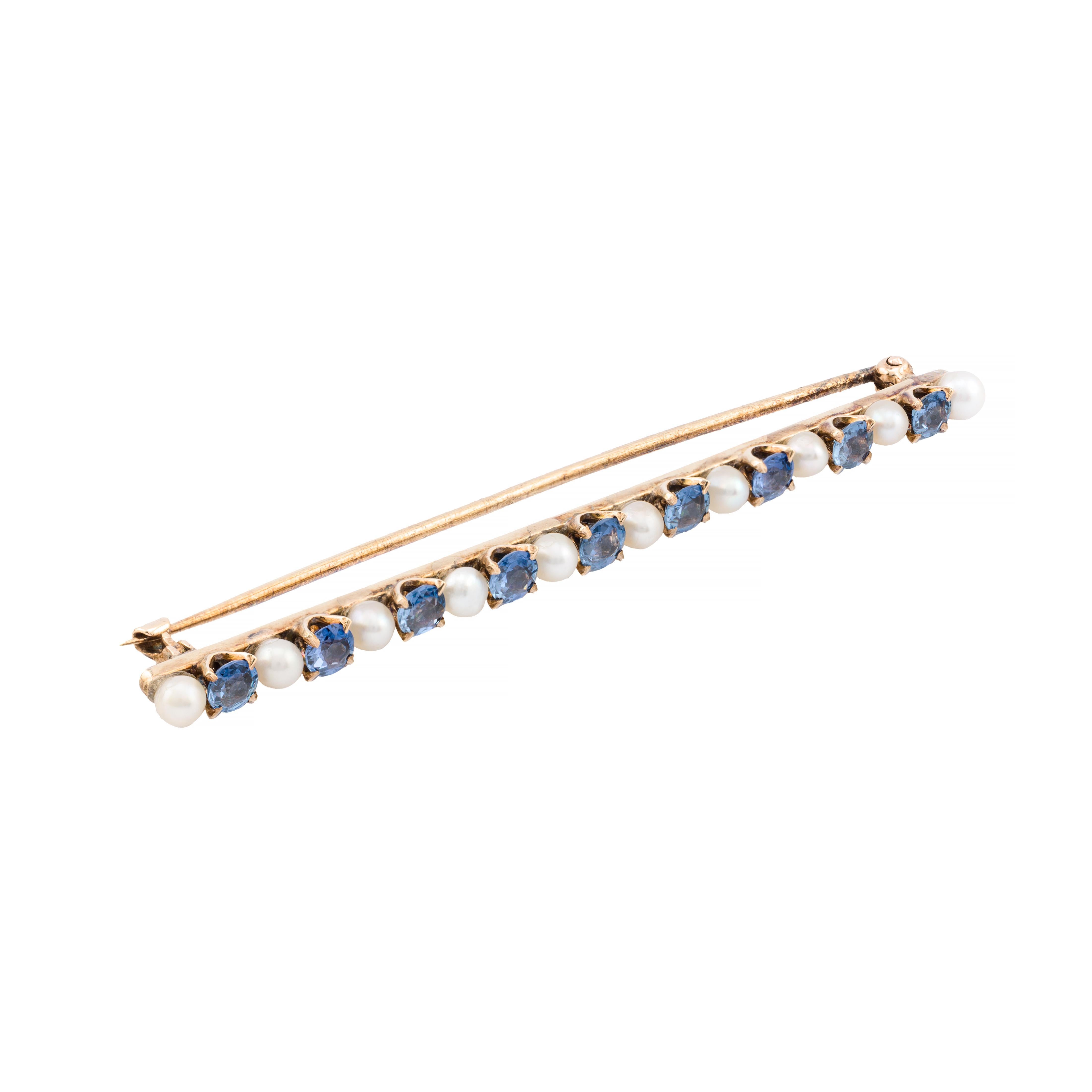 Aston Estate Jewelry Presents:

An exquisite Art Nouveau period brooch featuring rare Yogo Gulch sapphires. Crafted in lustrous 14k yellow gold, featuring alternating round blue sapphires and natural white pearls. The No Heat Yogo Gulch sapphires,
