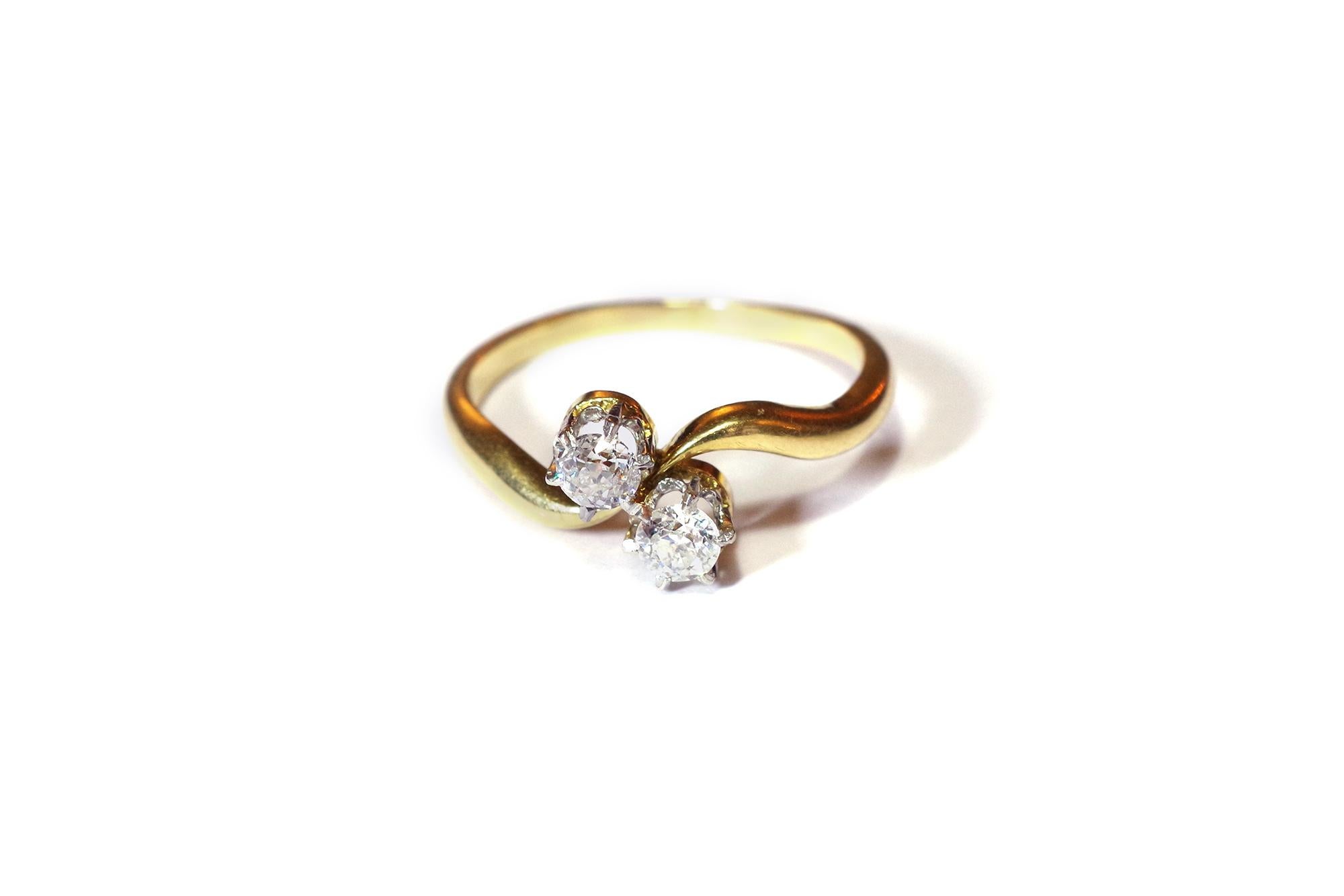 Antique You and Me ring in yellow gold 18 karats and platinum. The ring is centred by an old cut diamond and a brilliant cut diamond set by six claws in platinum. French antique ring, circa 1900.

Marked with a horse's head (1838-1919) and numbered